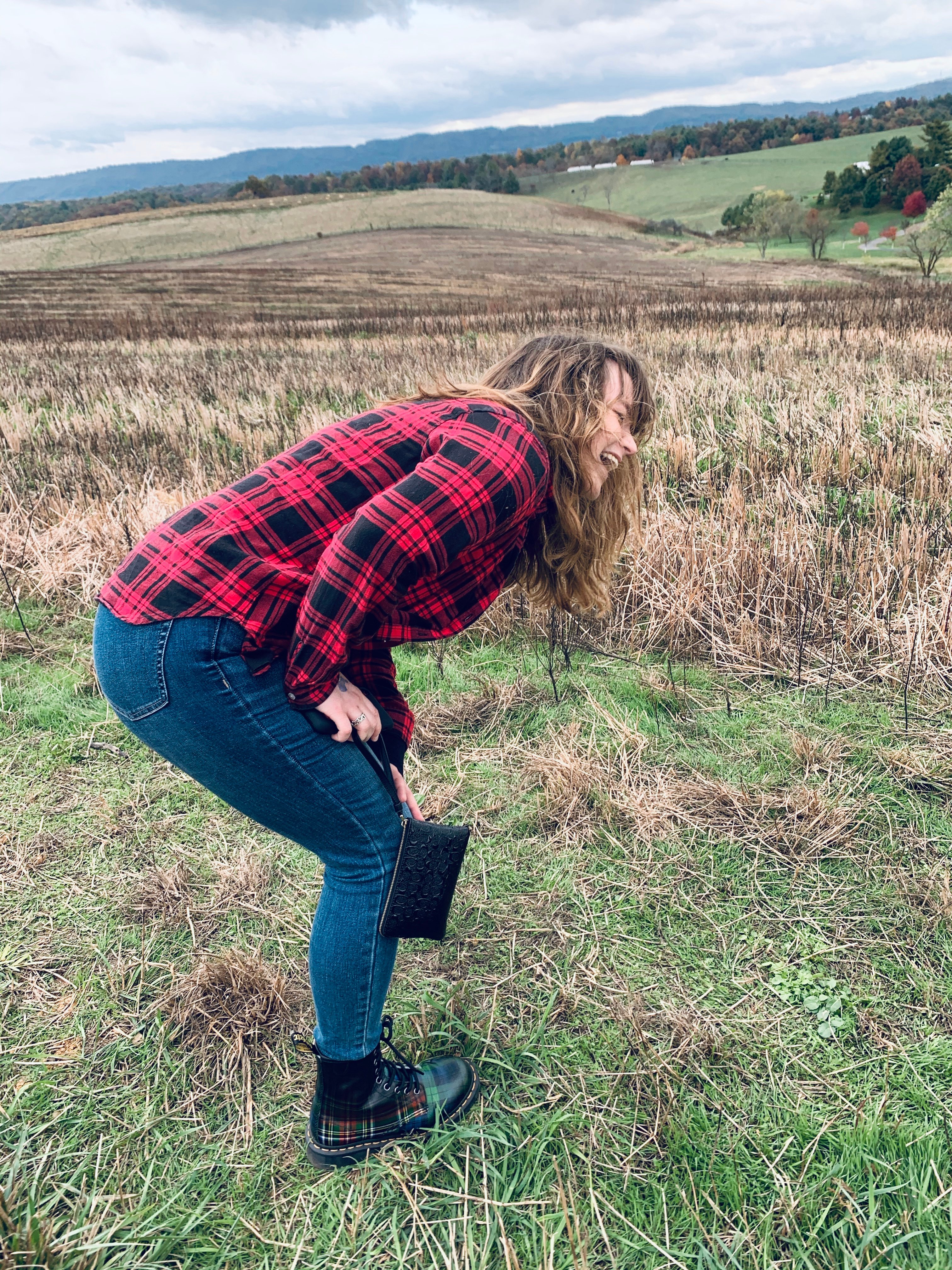 Woman bent over laughing