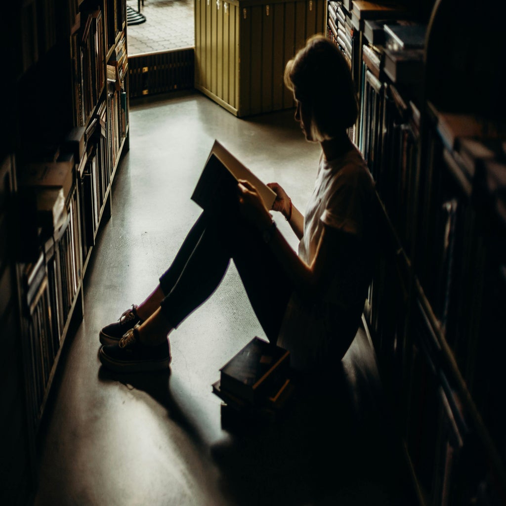 Woman sitting alone in a library