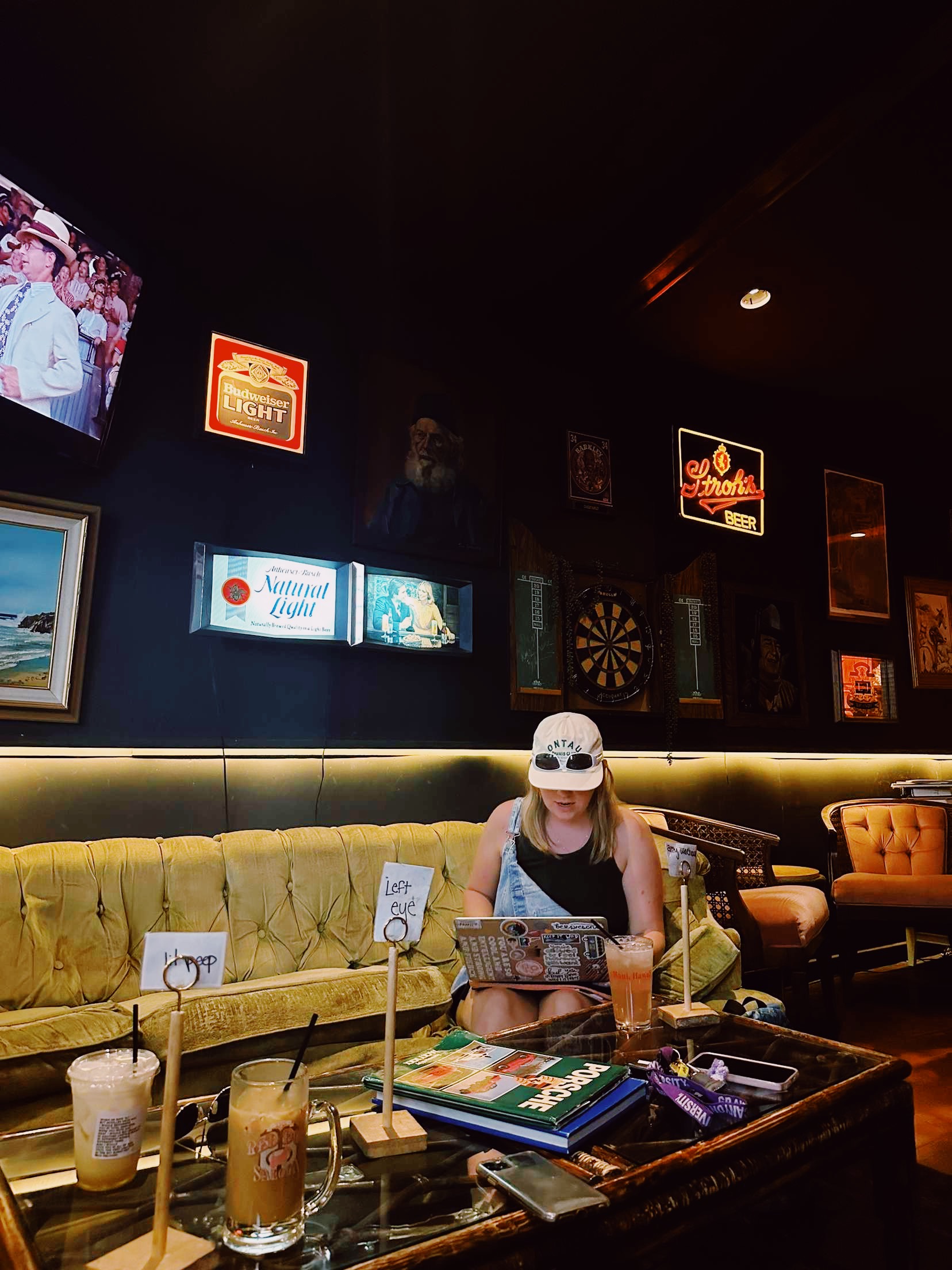 Hannah Warren, Spoon GCU Chapter President, sitting on a couch with a laptop in a coffee shop.