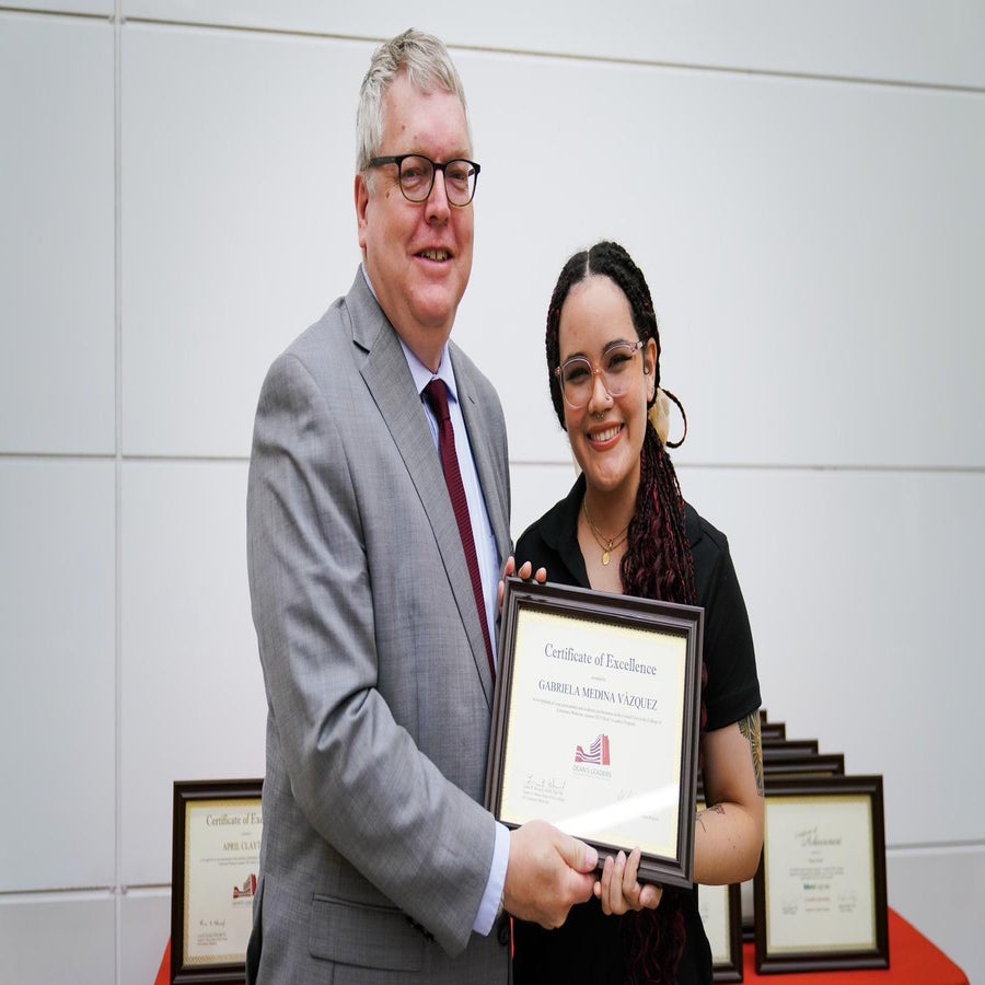 Gabriela Medina holding Dean Leaders certificate at Cornell