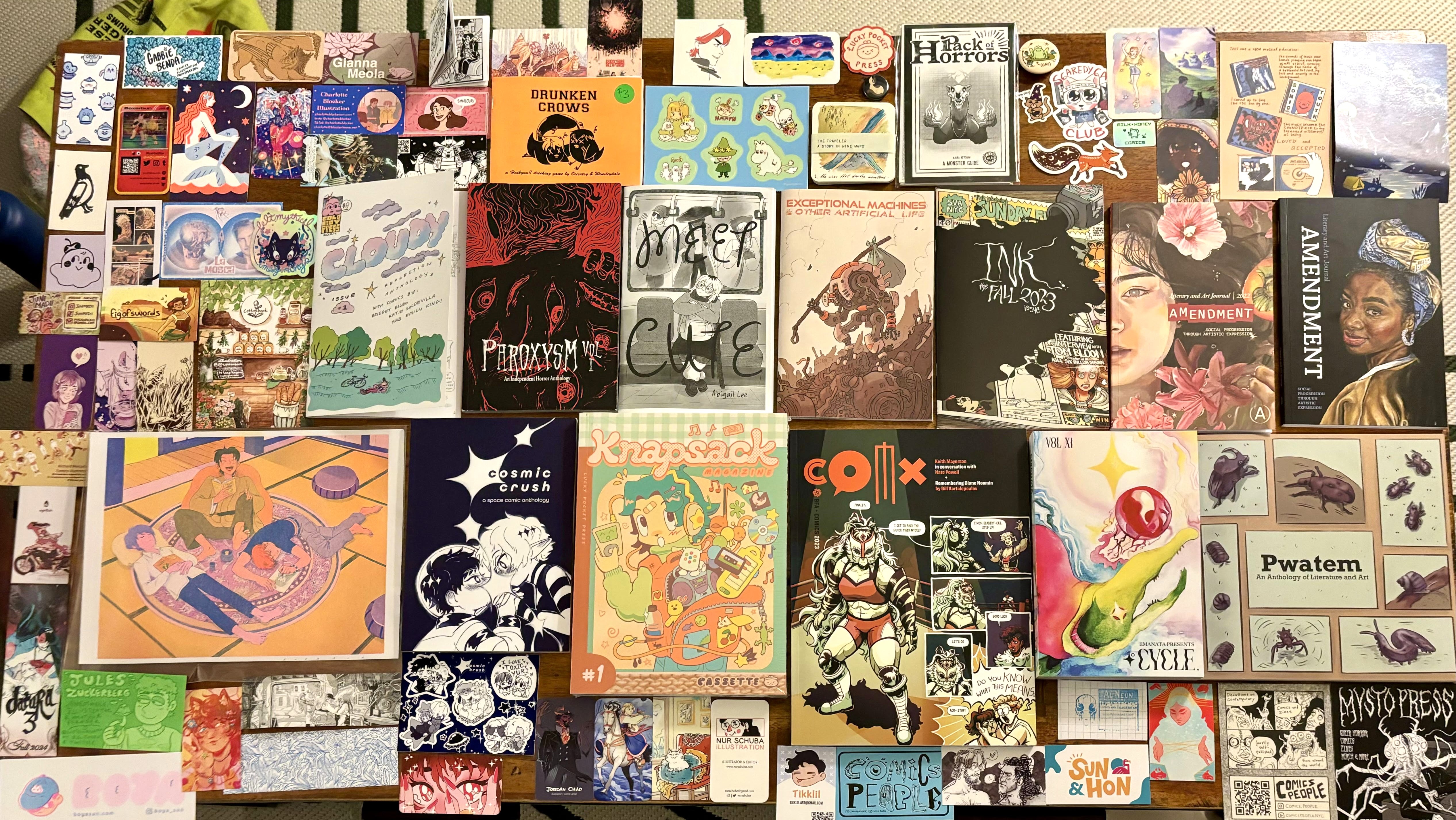 collection of art and zines spread out on a table