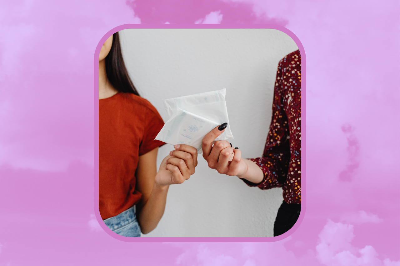 Women handing each other menstrual care products.