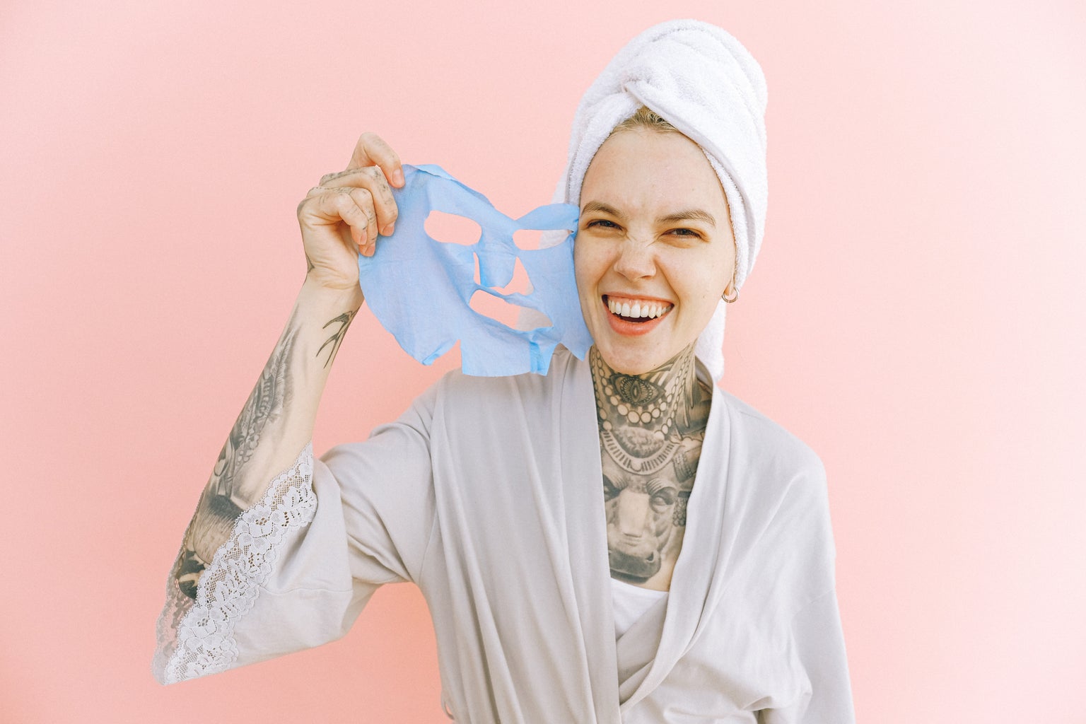 happy woman removing a face mask