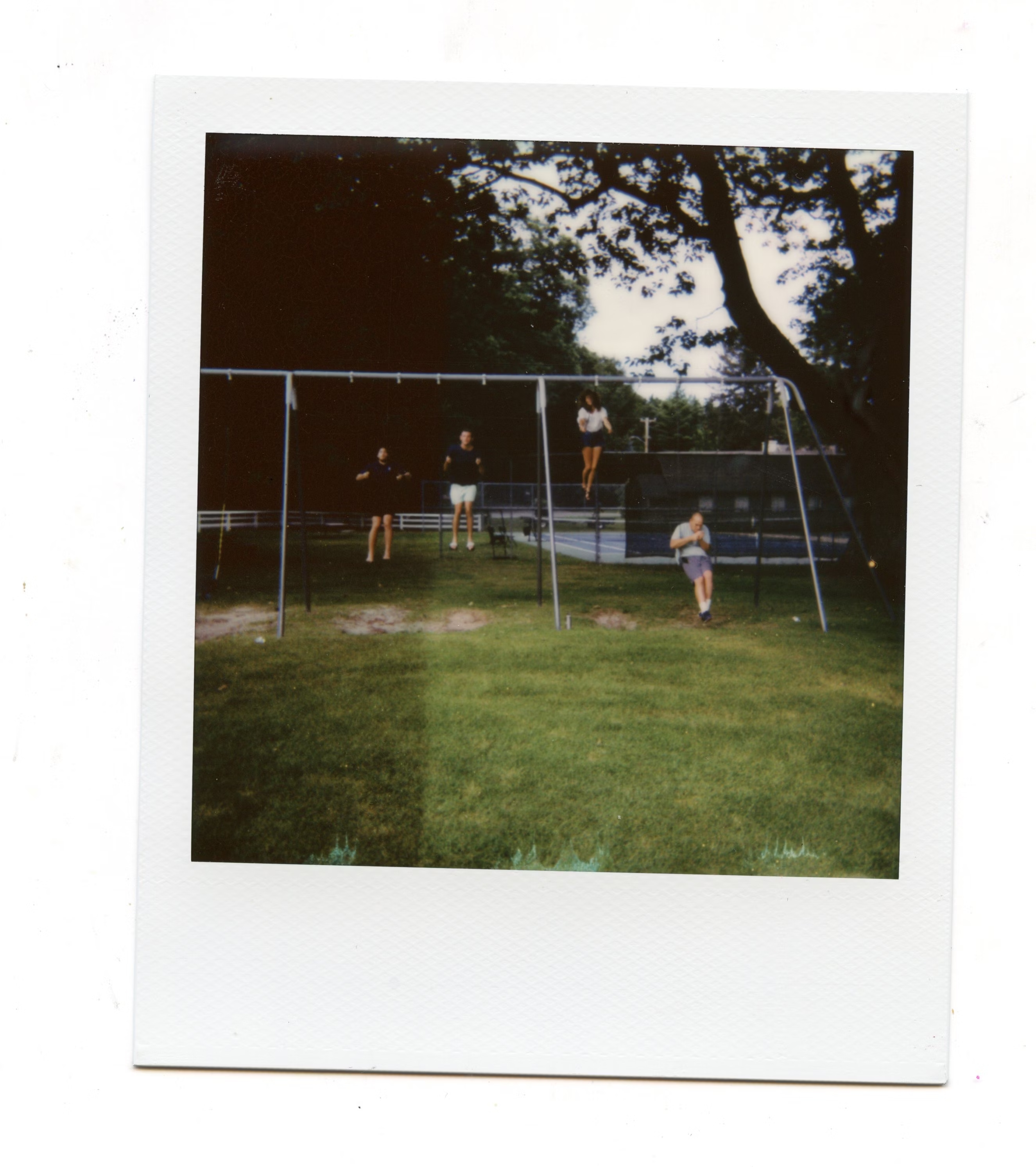 polaroid picture of friends in a swing