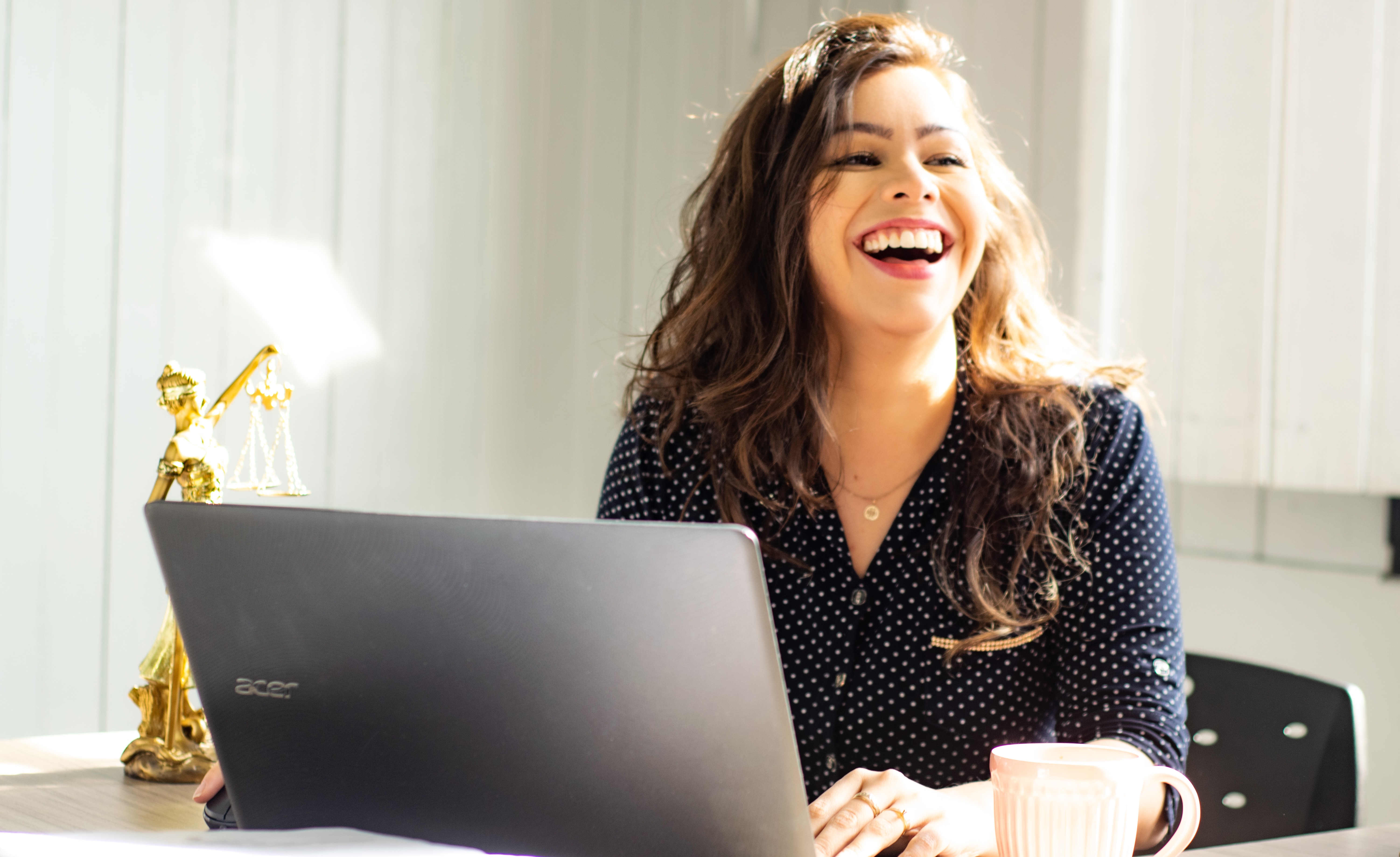 woman at laptop laughing