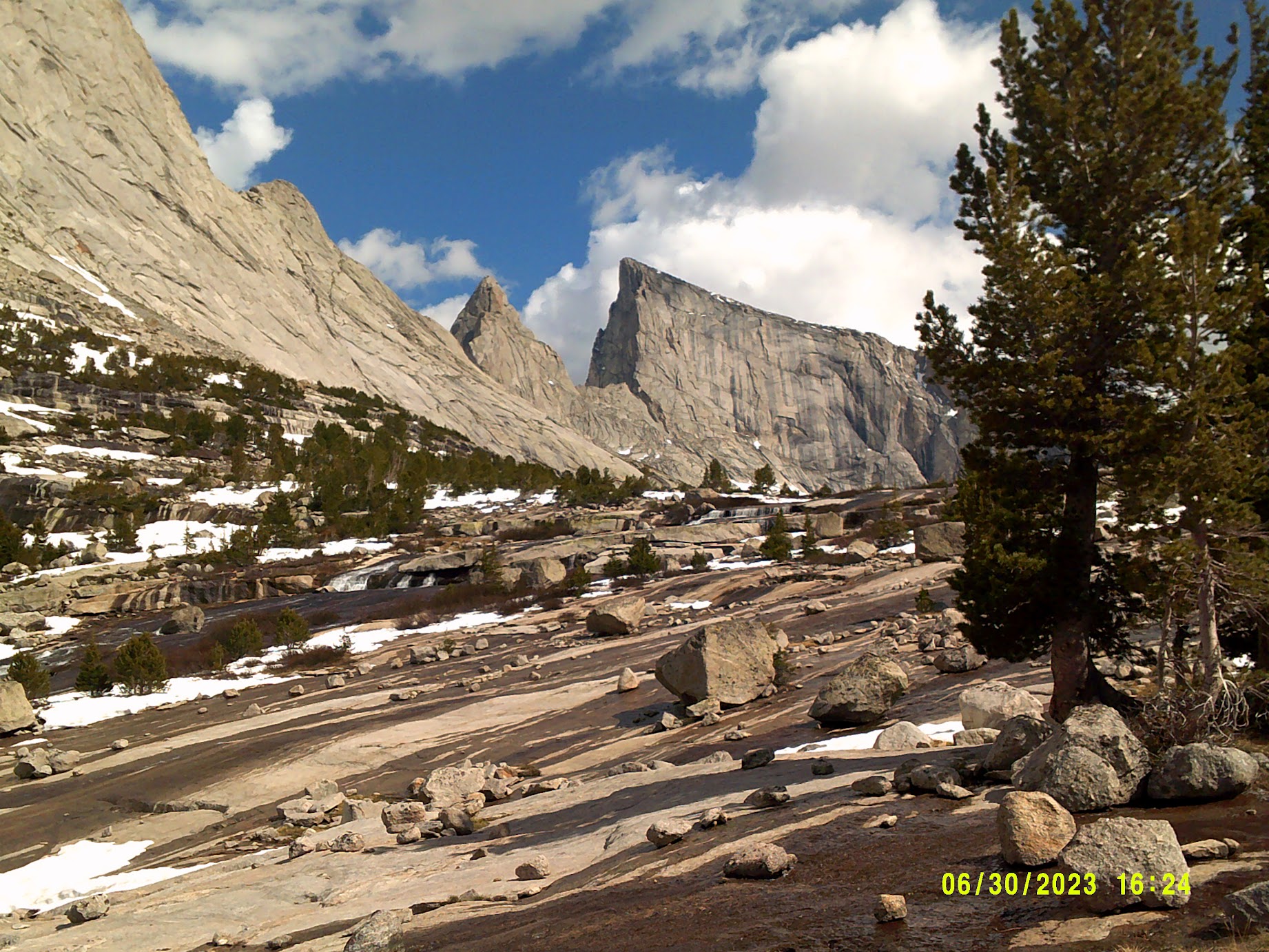 Small waterfall between granite slabs and a view of East Temple Peak near Deep Lake, Wyoming.