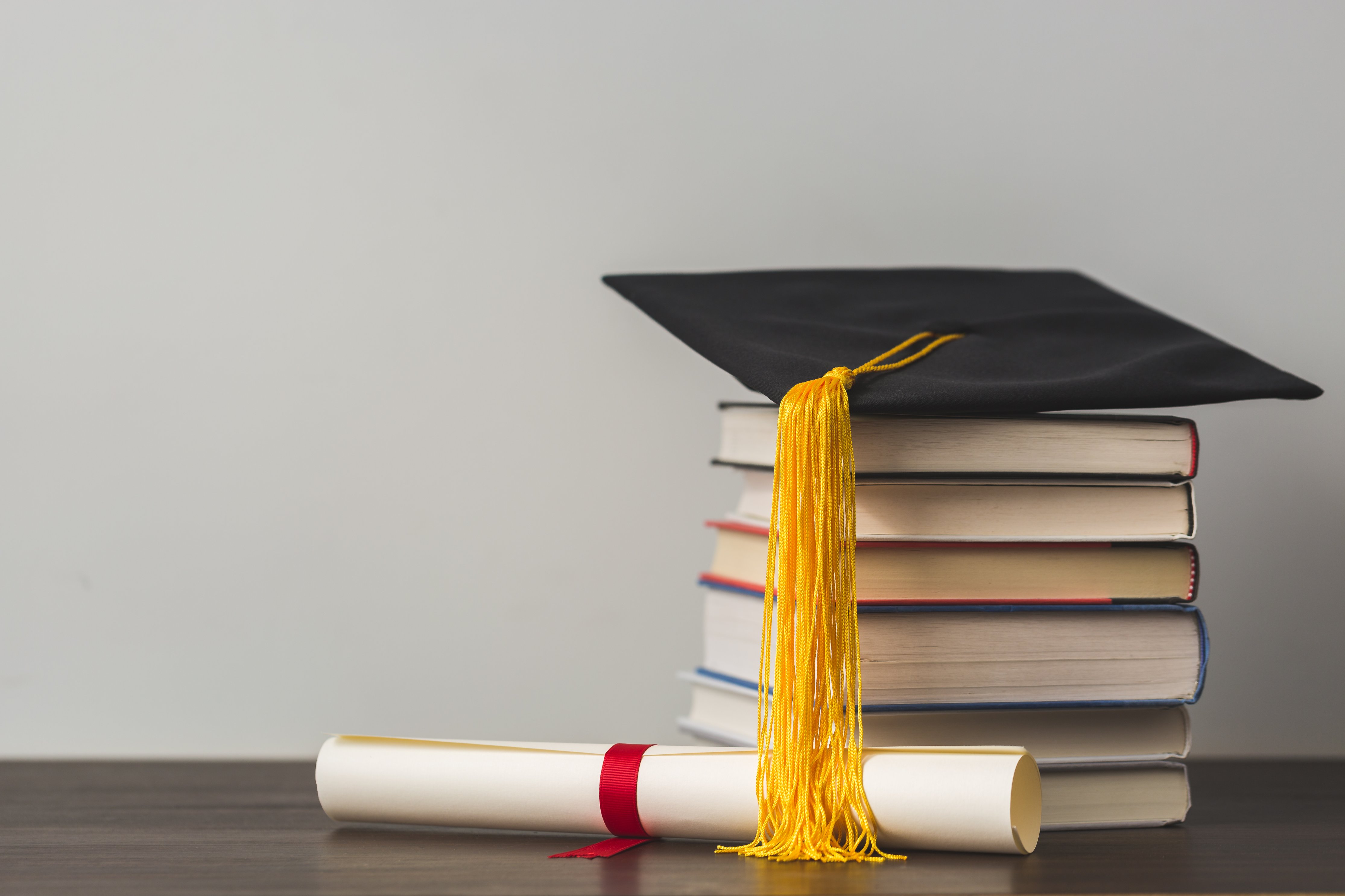Books and graduation cap.