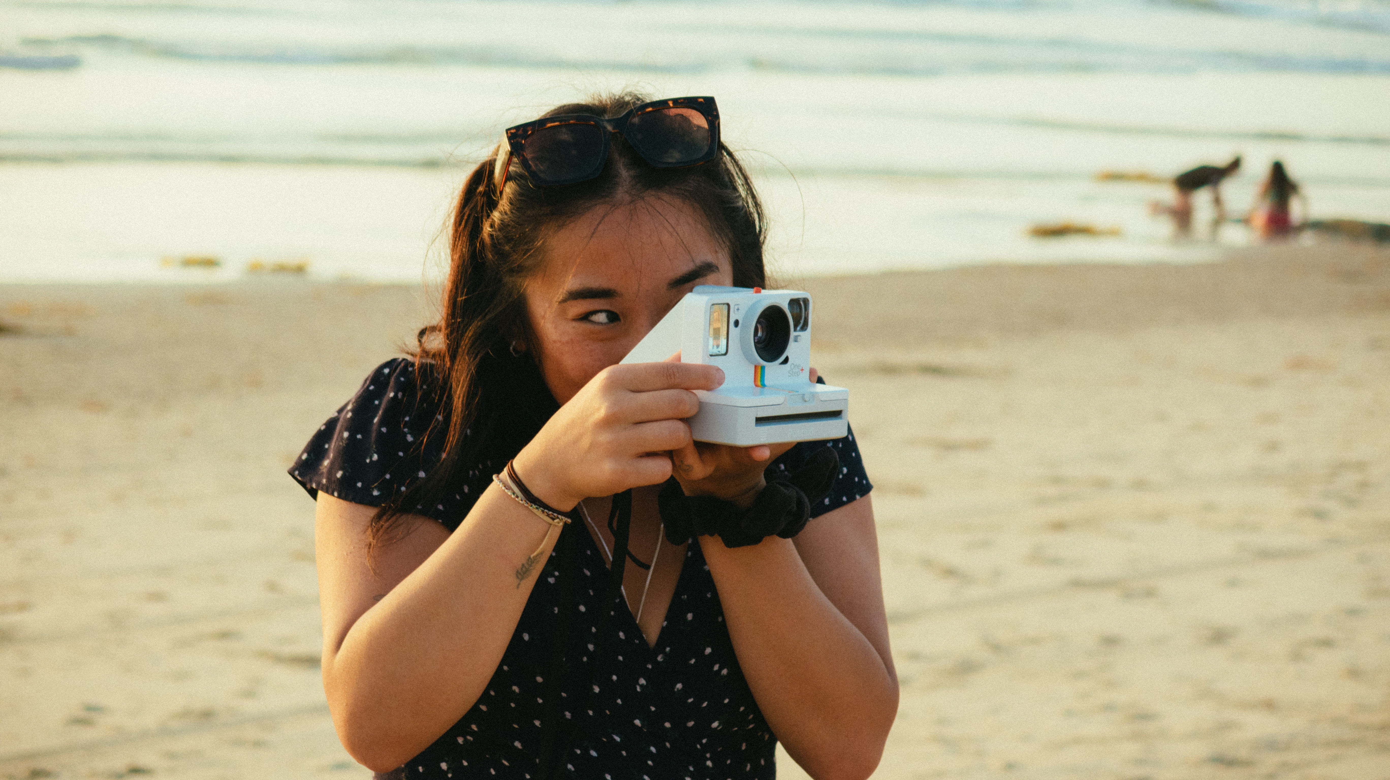 Woman taking a polaroid photo.