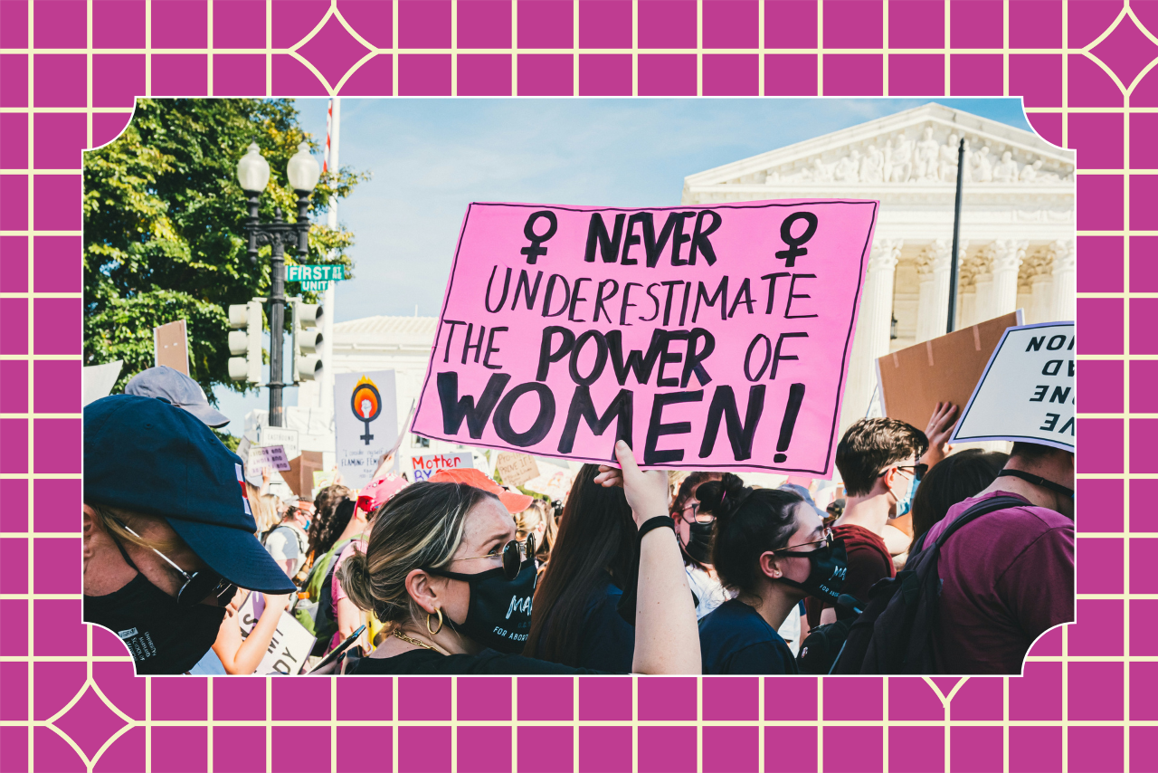 Women at a march hold a sign