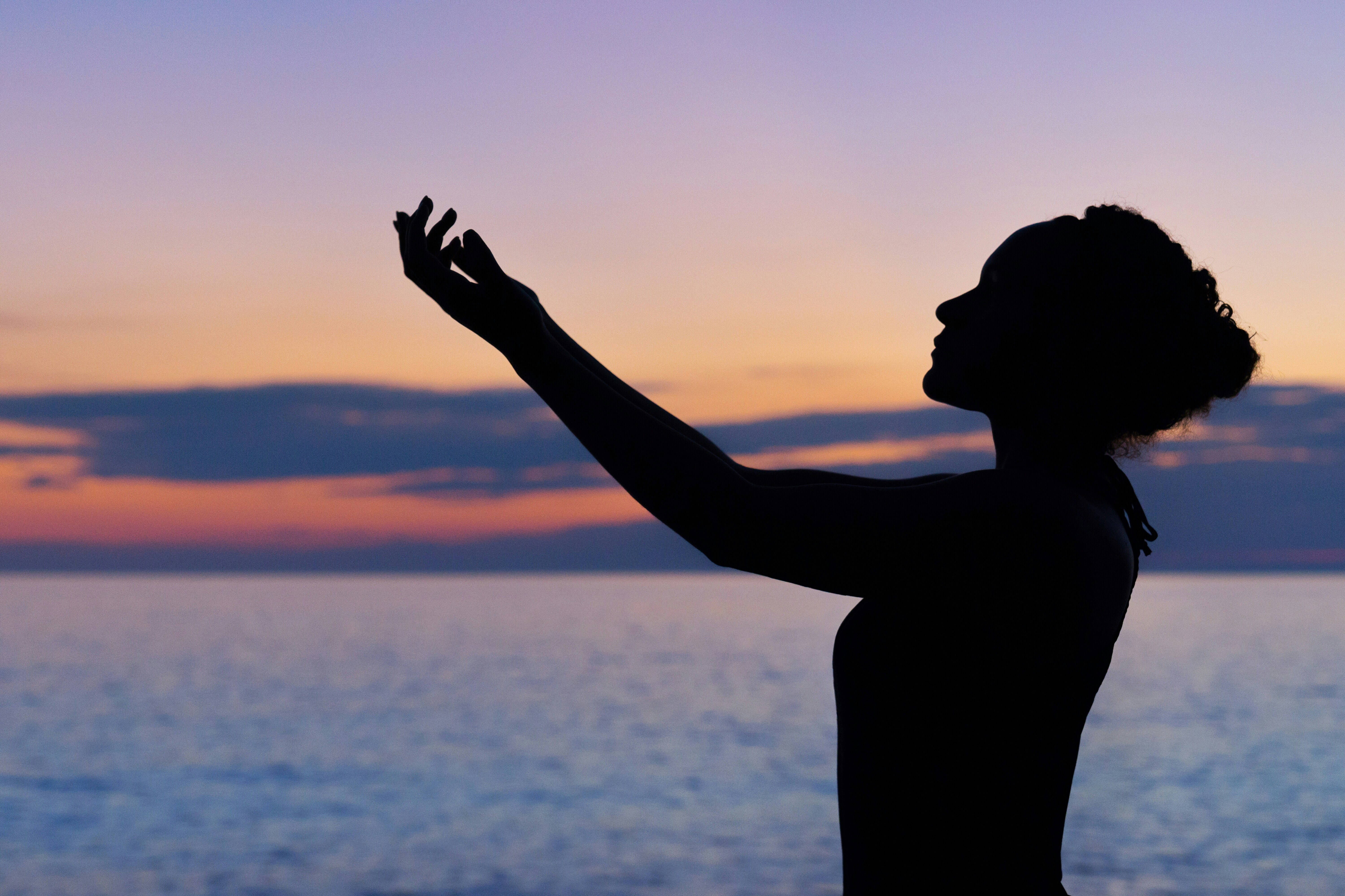 silhouette of a woman posing during sunrise