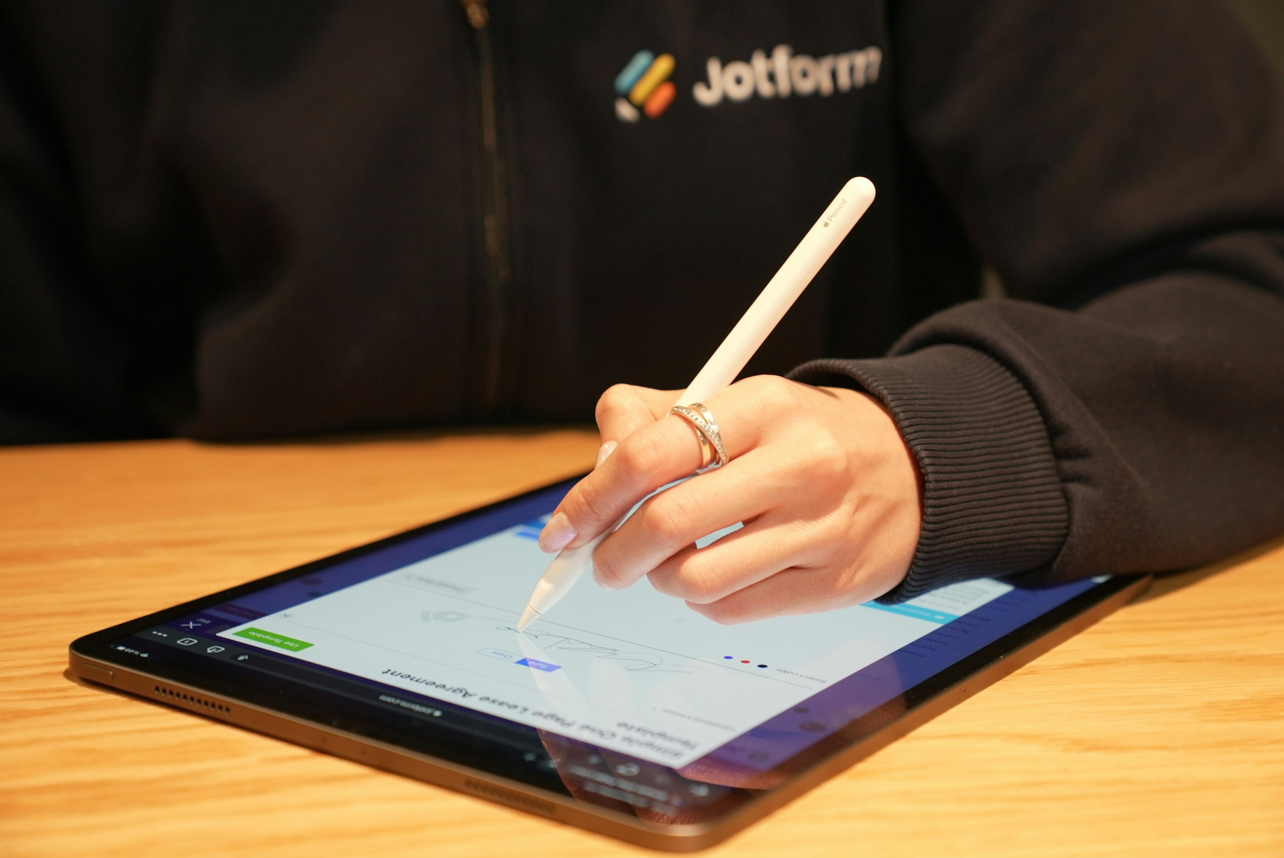 Person writing on a tablet.
