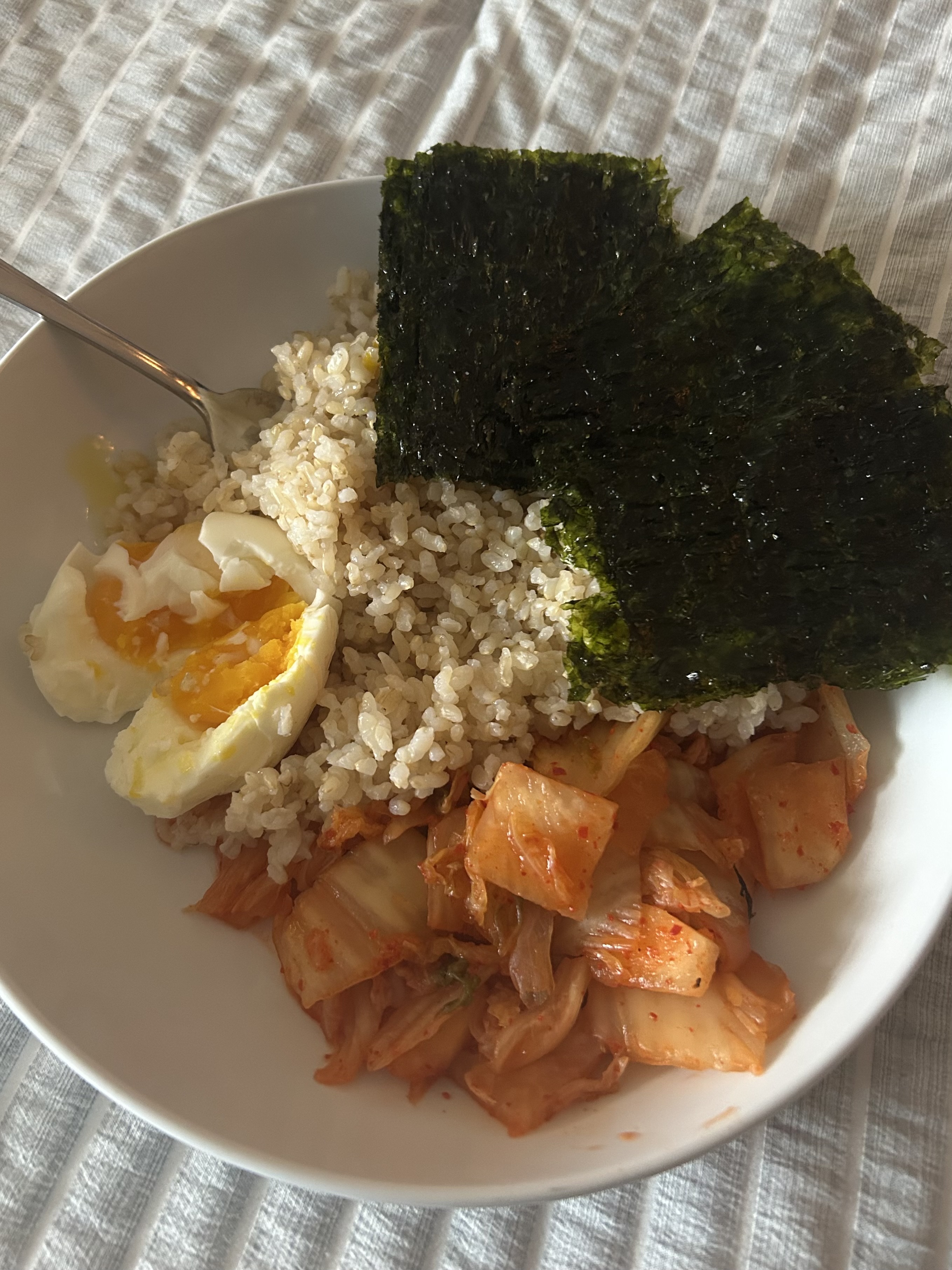 Rice, seaweed, egg, and kimchi in a bowl