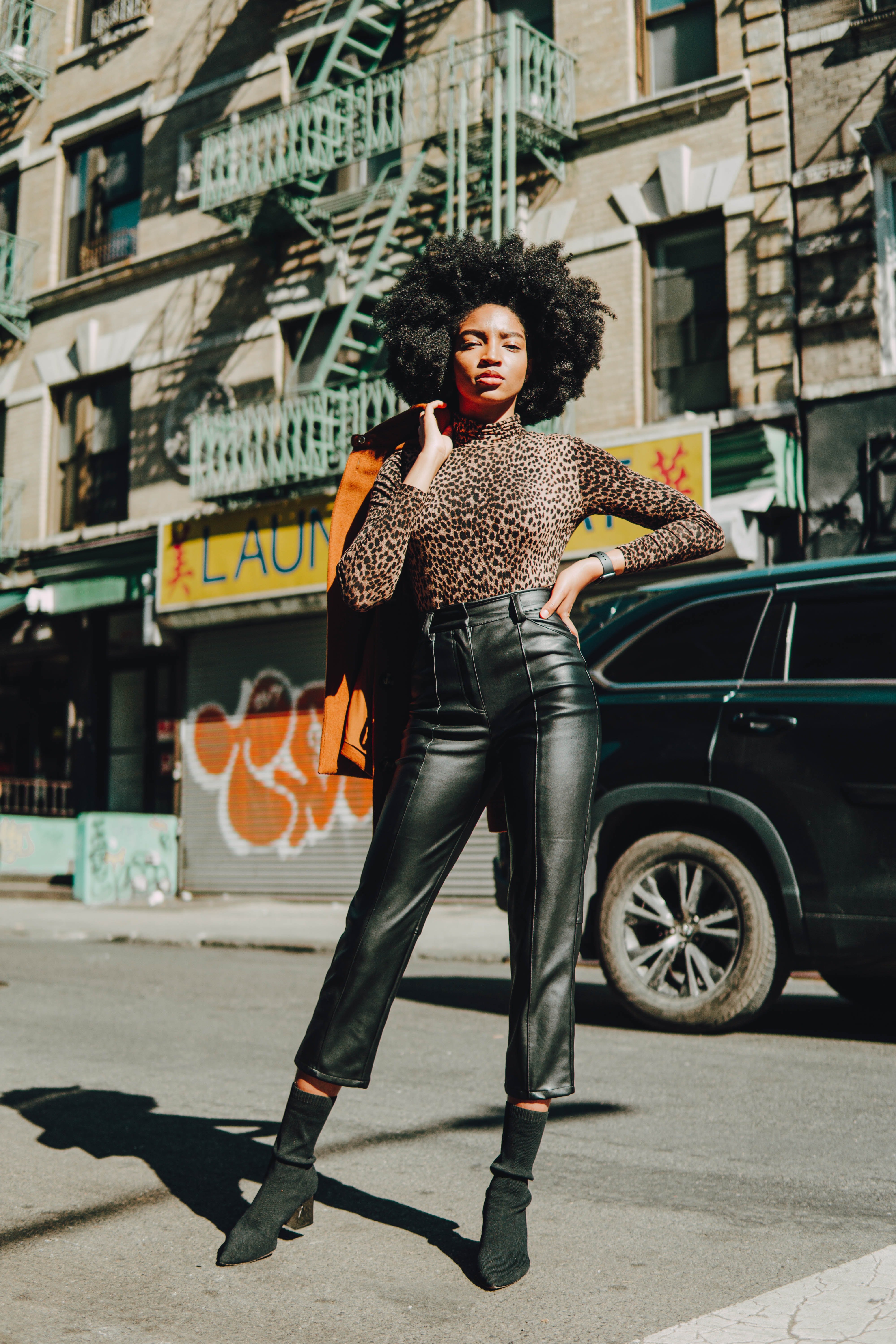 fashionable woman standing in street by Juan Ordonez