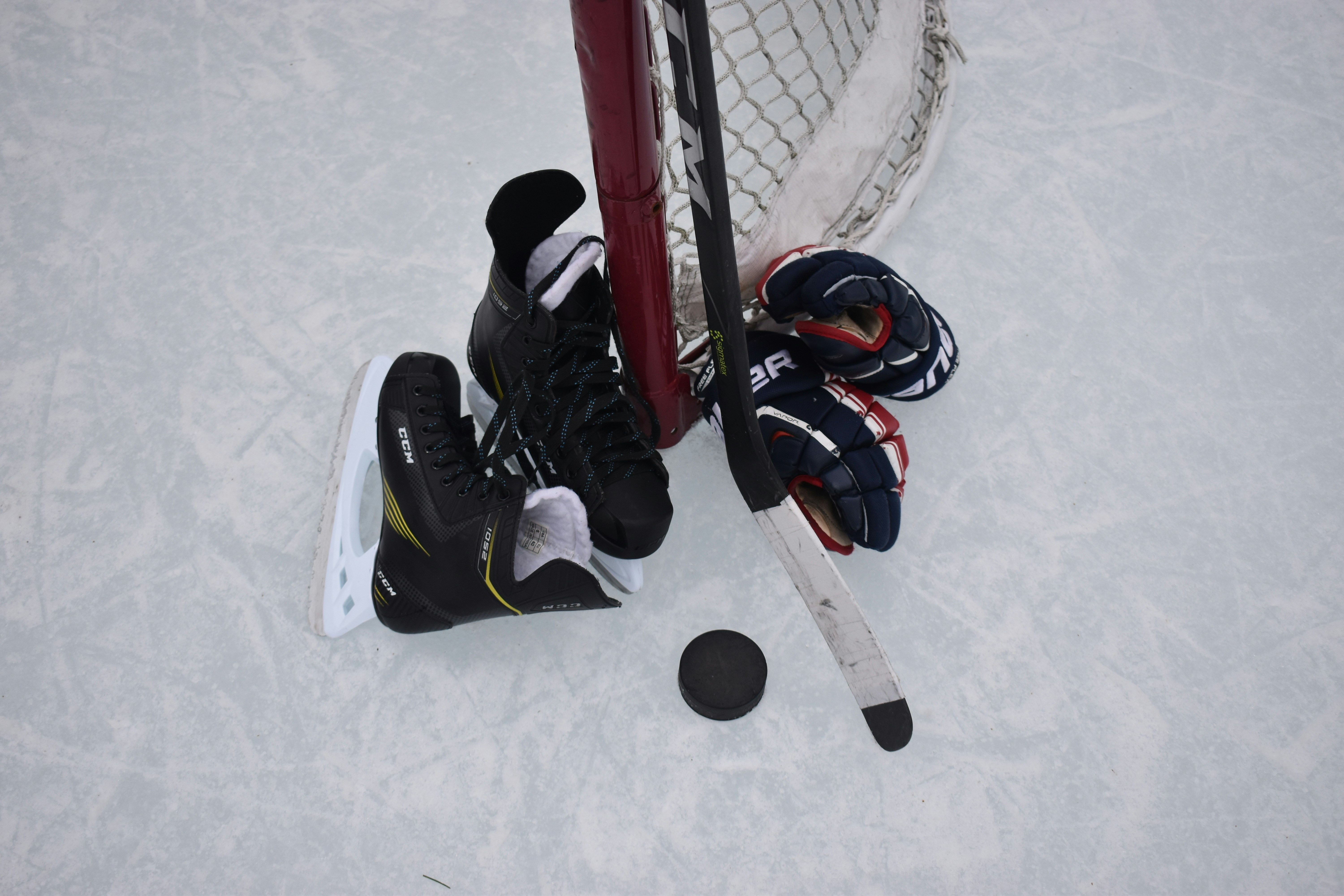 An above shot of hockey equipment on ice.