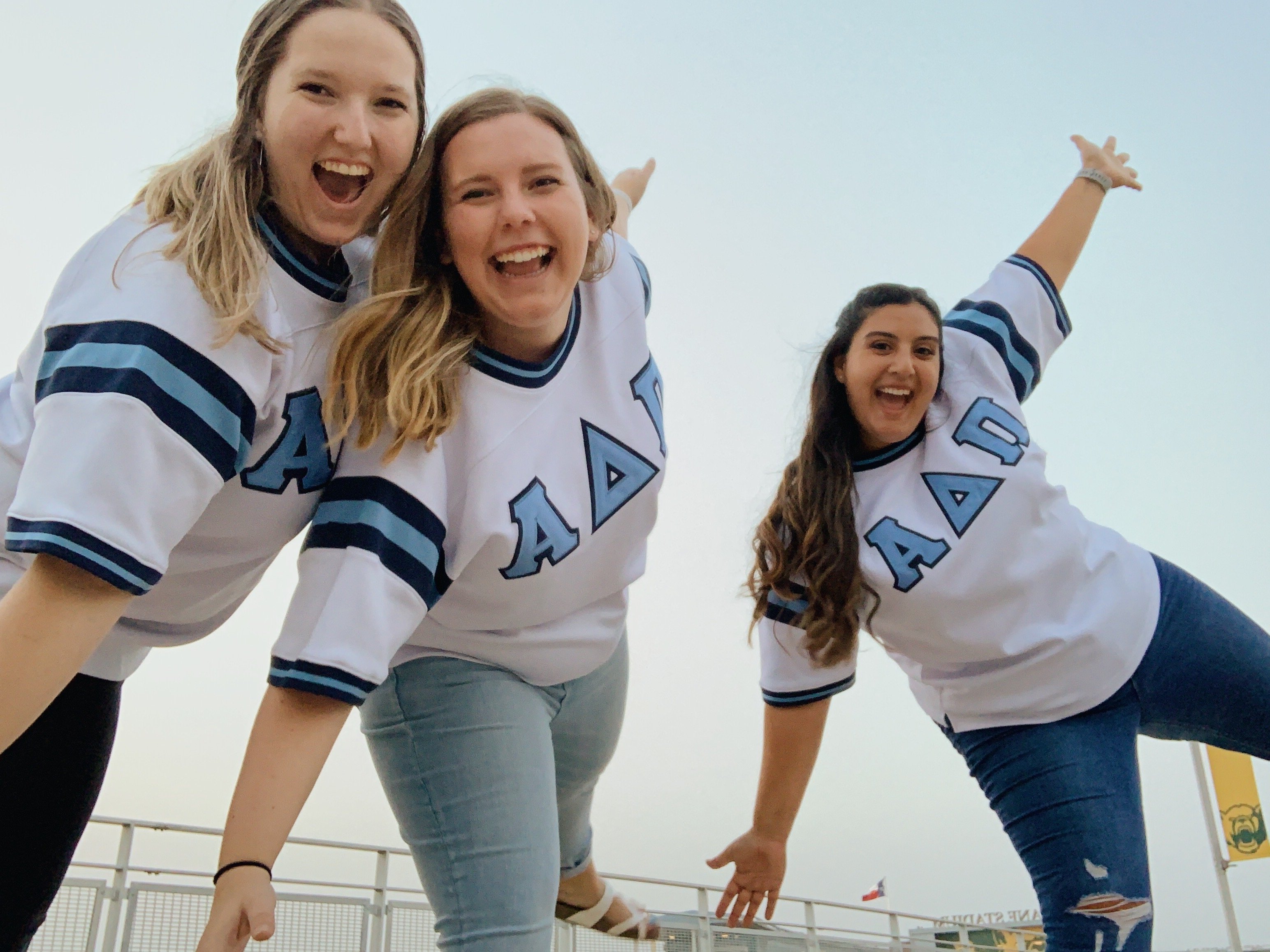 Three friends in sorority jerseys