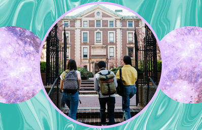 back view of three students walking on a college campus