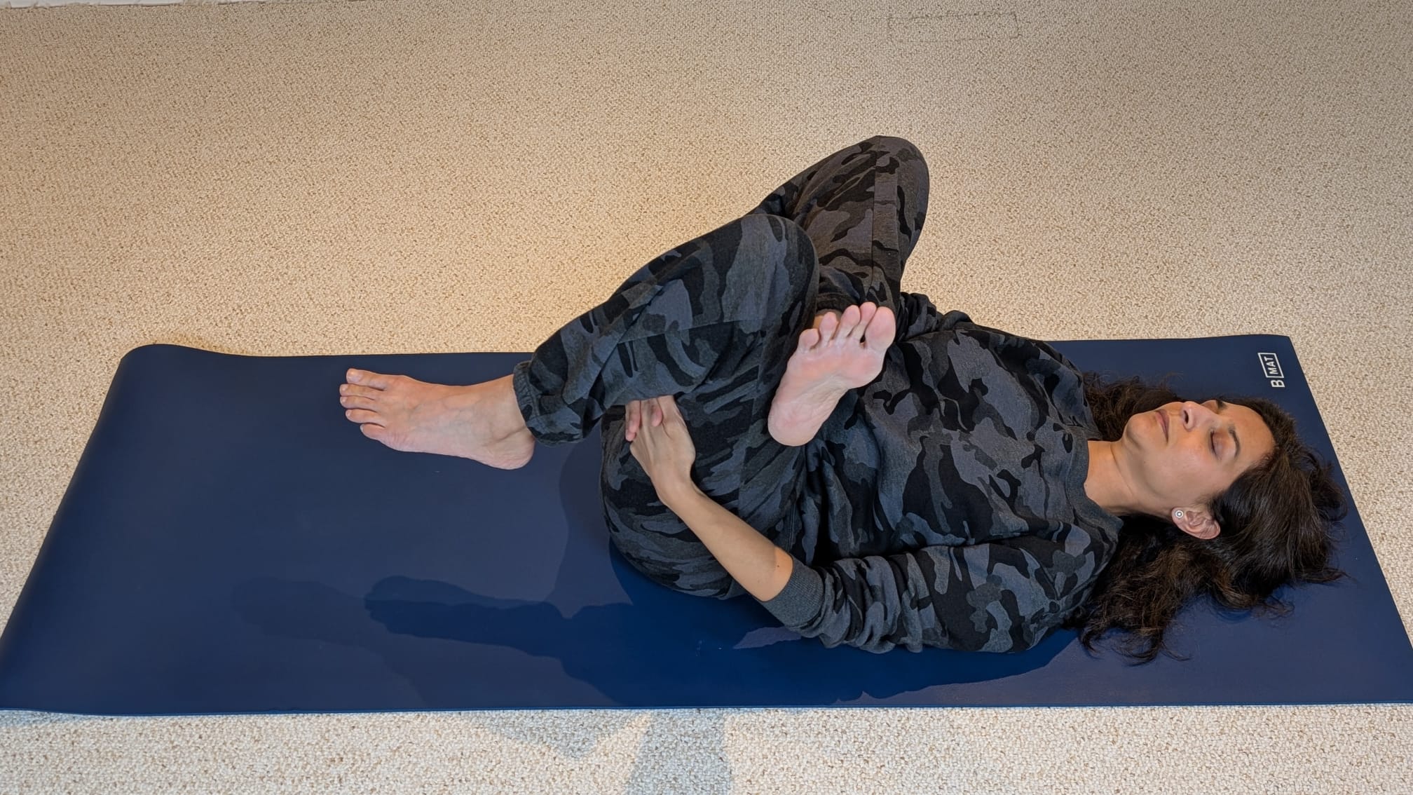 Woman in reclined pigeon pose