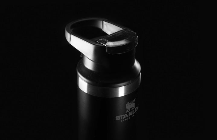 Black Stanley water bottle with all black background