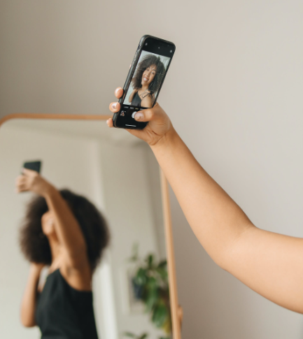 Woman smiling while taking a selfie