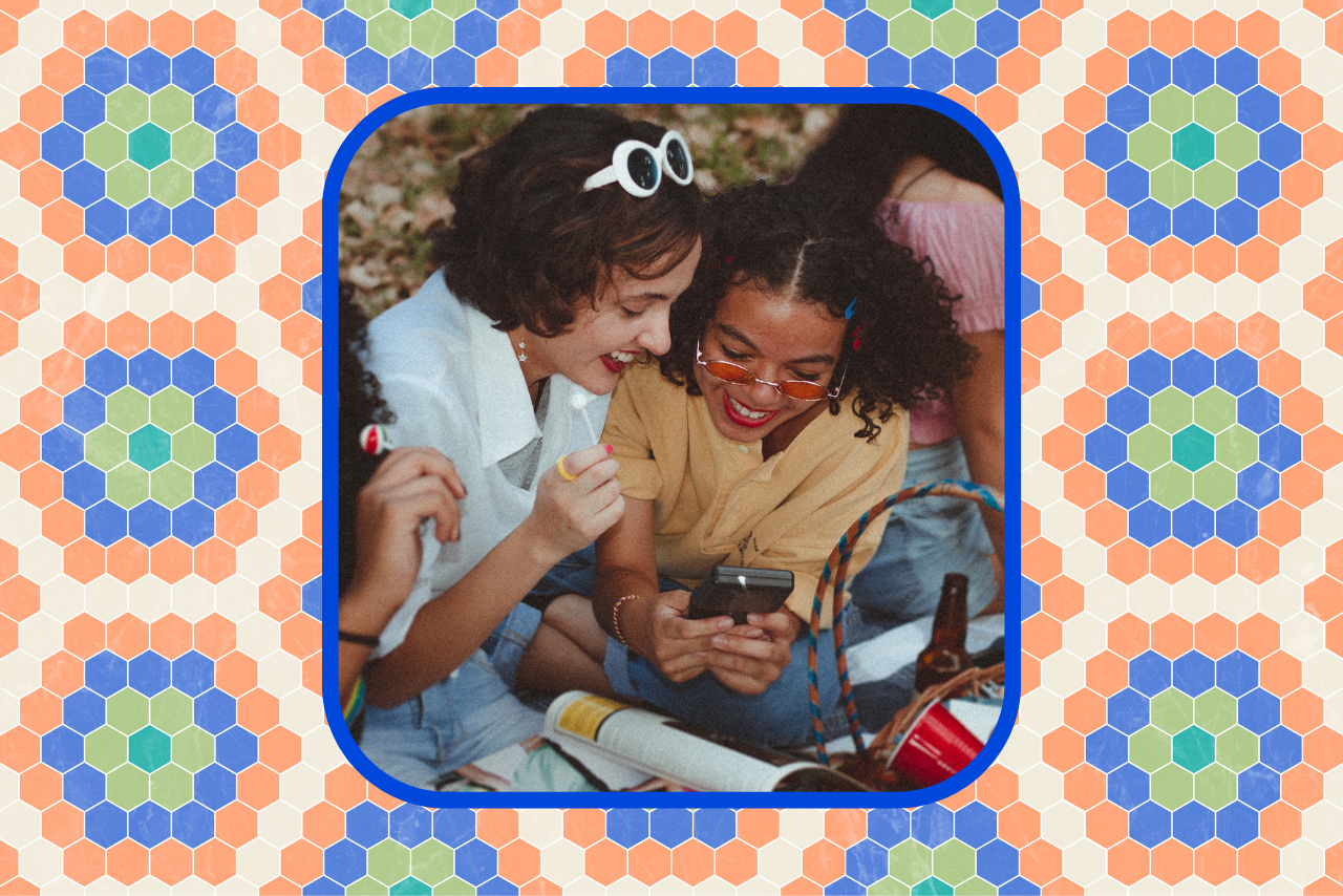 two friends smiling at phone