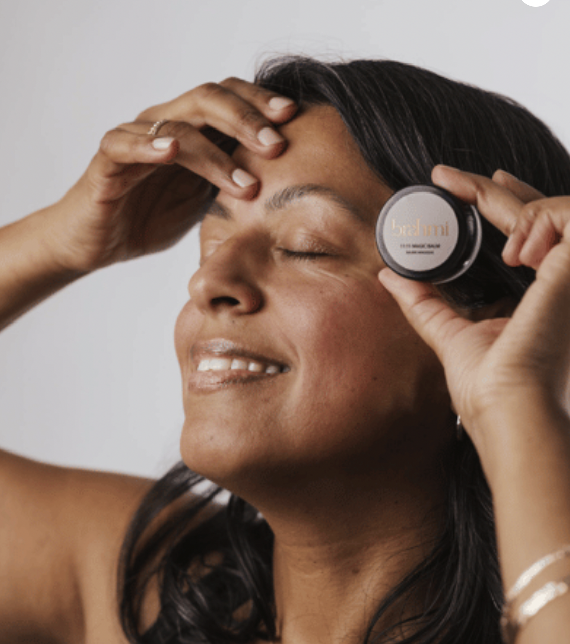 Brahmi Skincare Holiday Set. Woman with balm