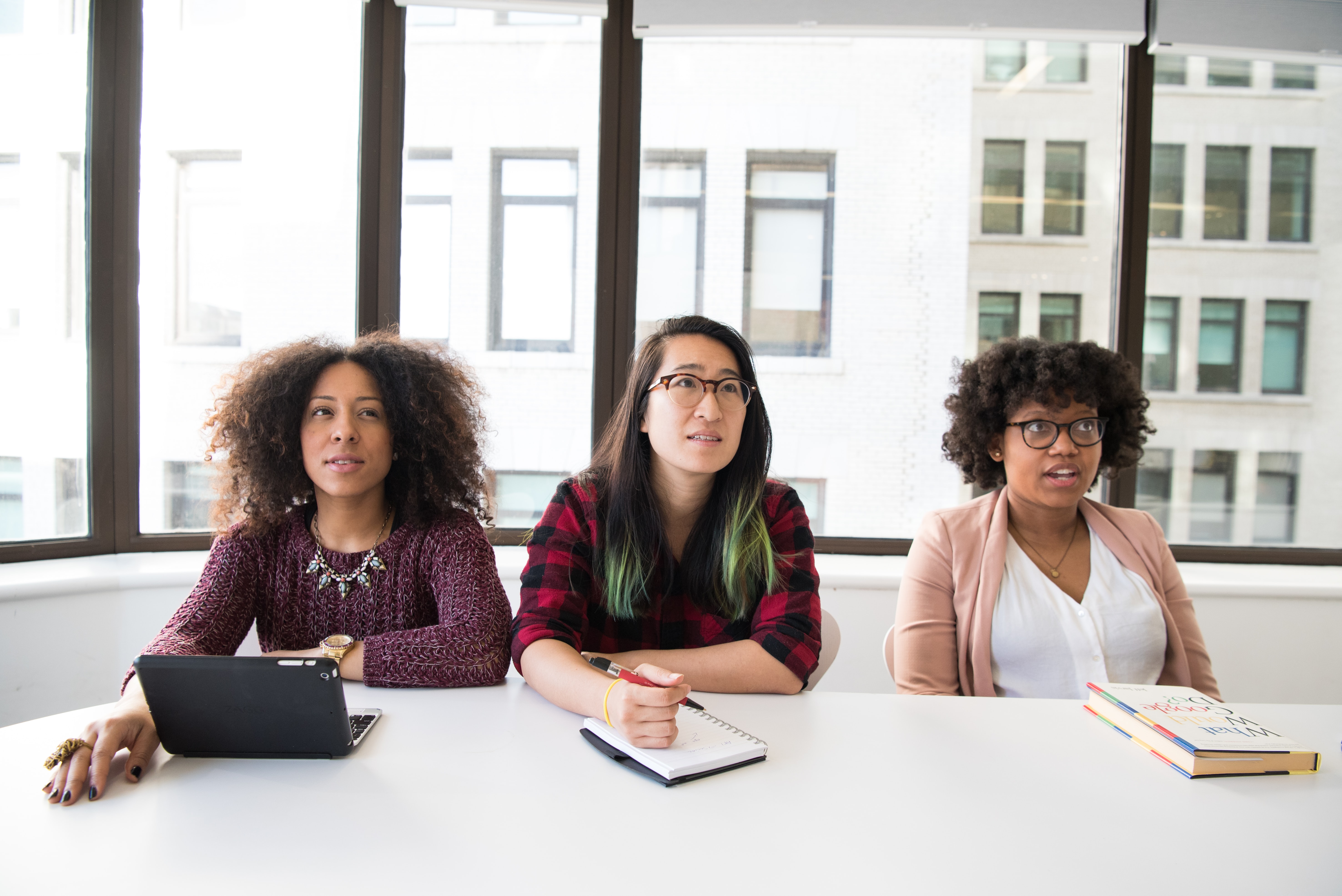 Women looking surprised during meeting