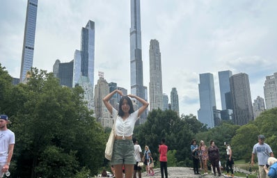 woman (me) at central park with buildings in the background