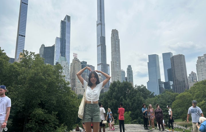 woman (me) at central park with buildings in the background