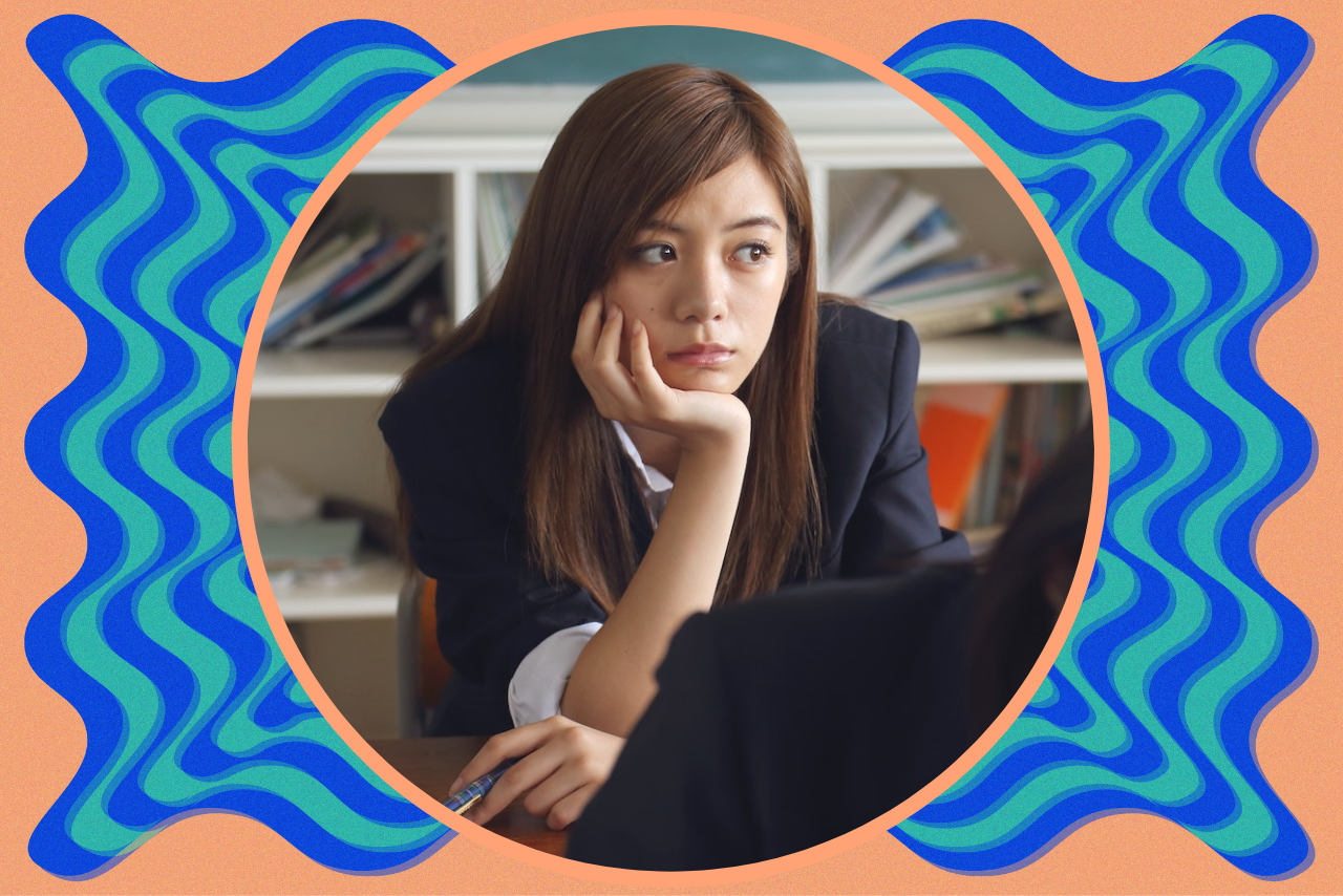 girl in classroom looking stressed/bored