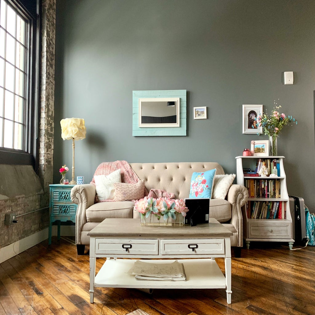 Cozy living room with couch and bookshelf.