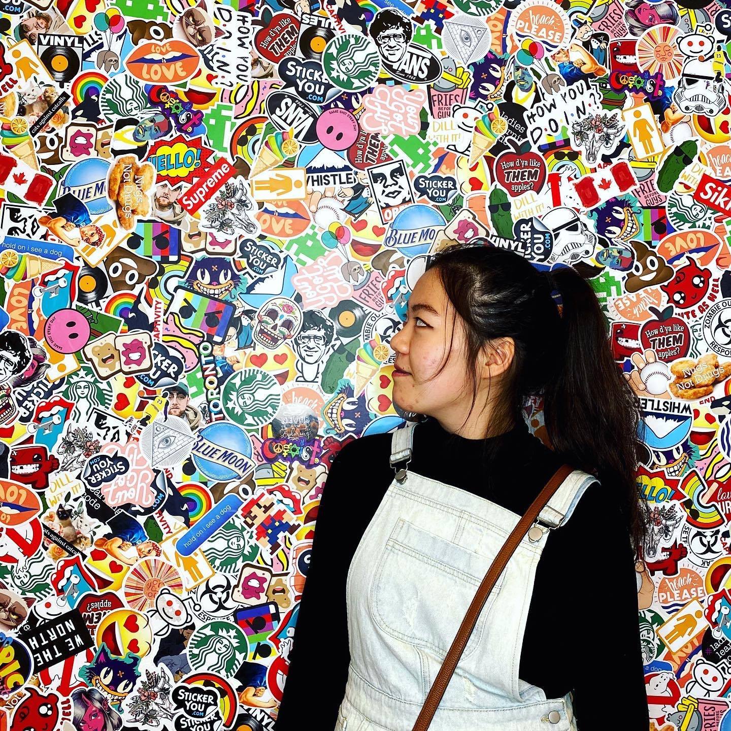 Emily Lin in front of sticker wall