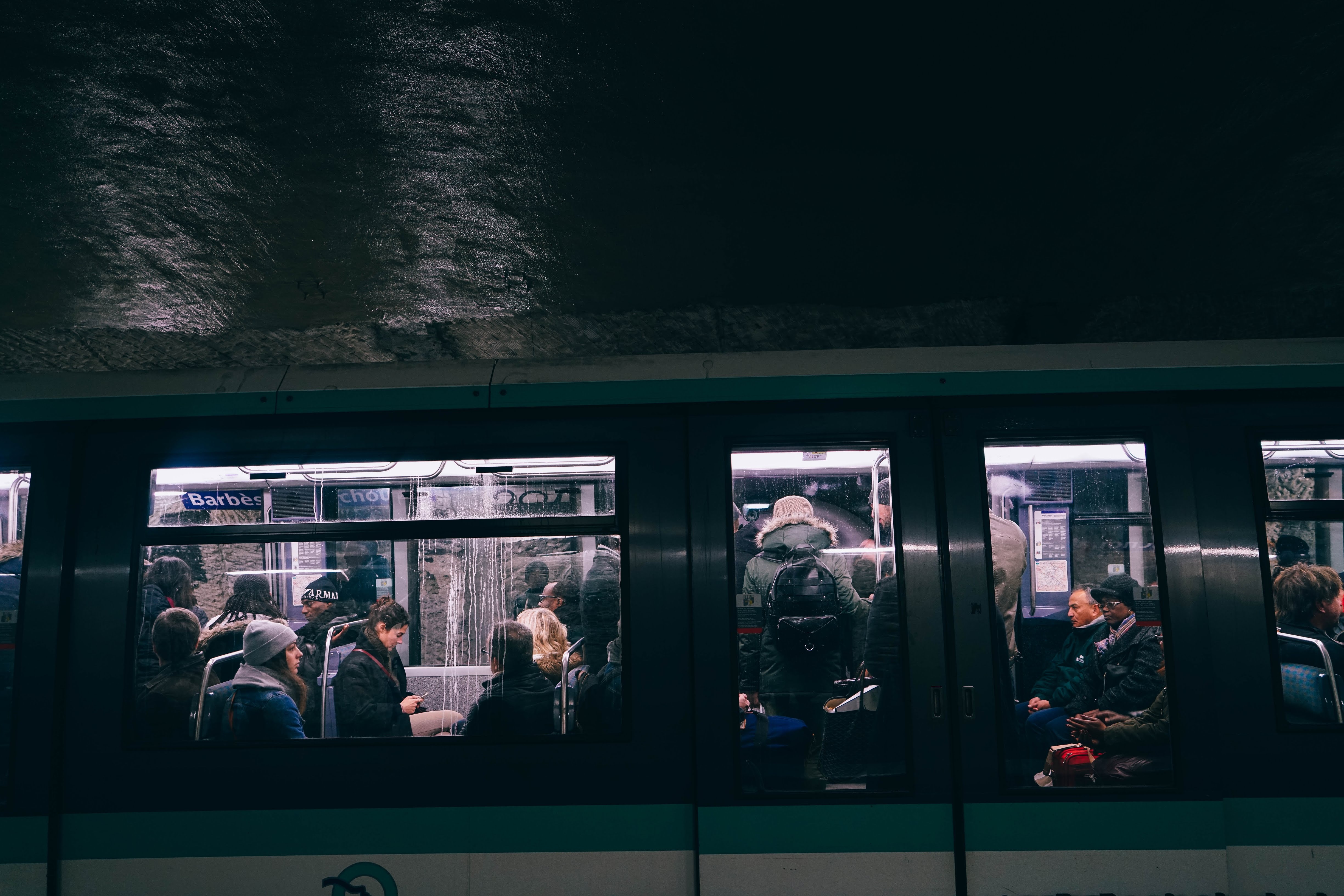 People inside a black, blue and white bus at night