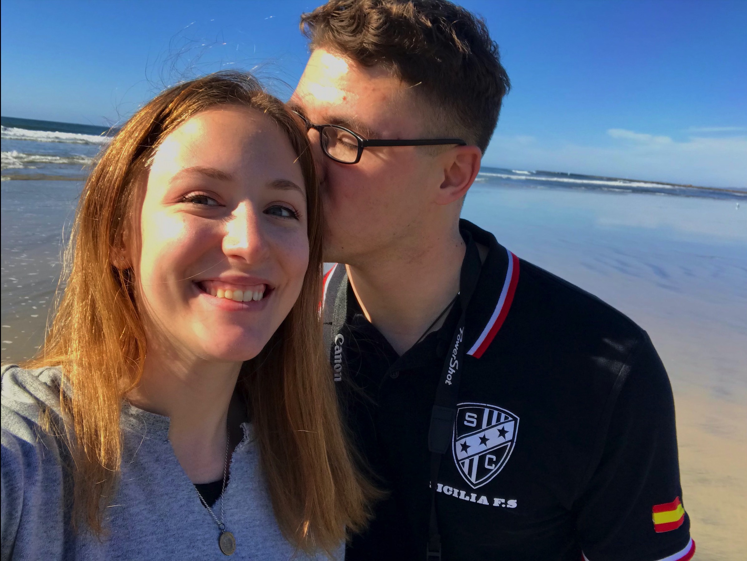 Man kissing woman on the cheek at the beach
