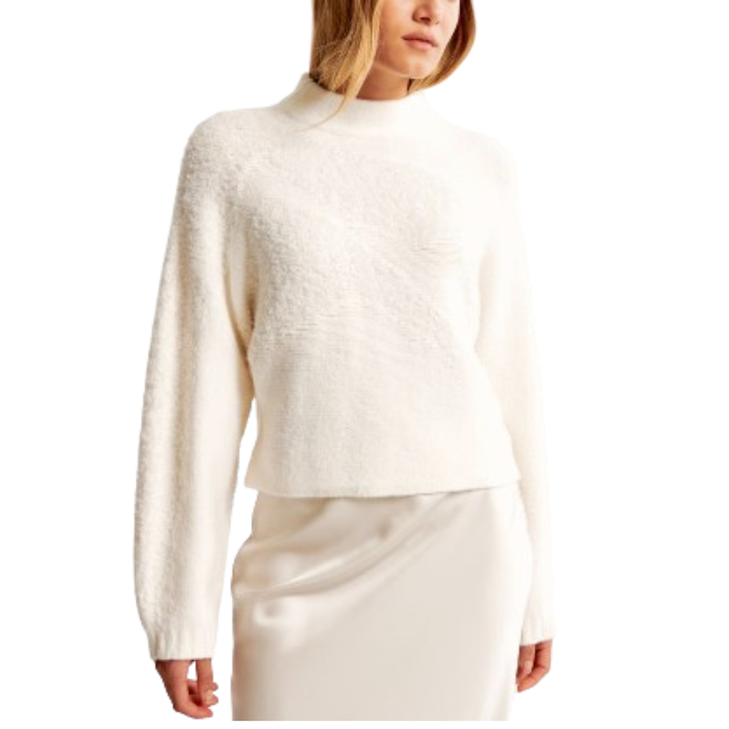 woman wearing a cream knit sweater
