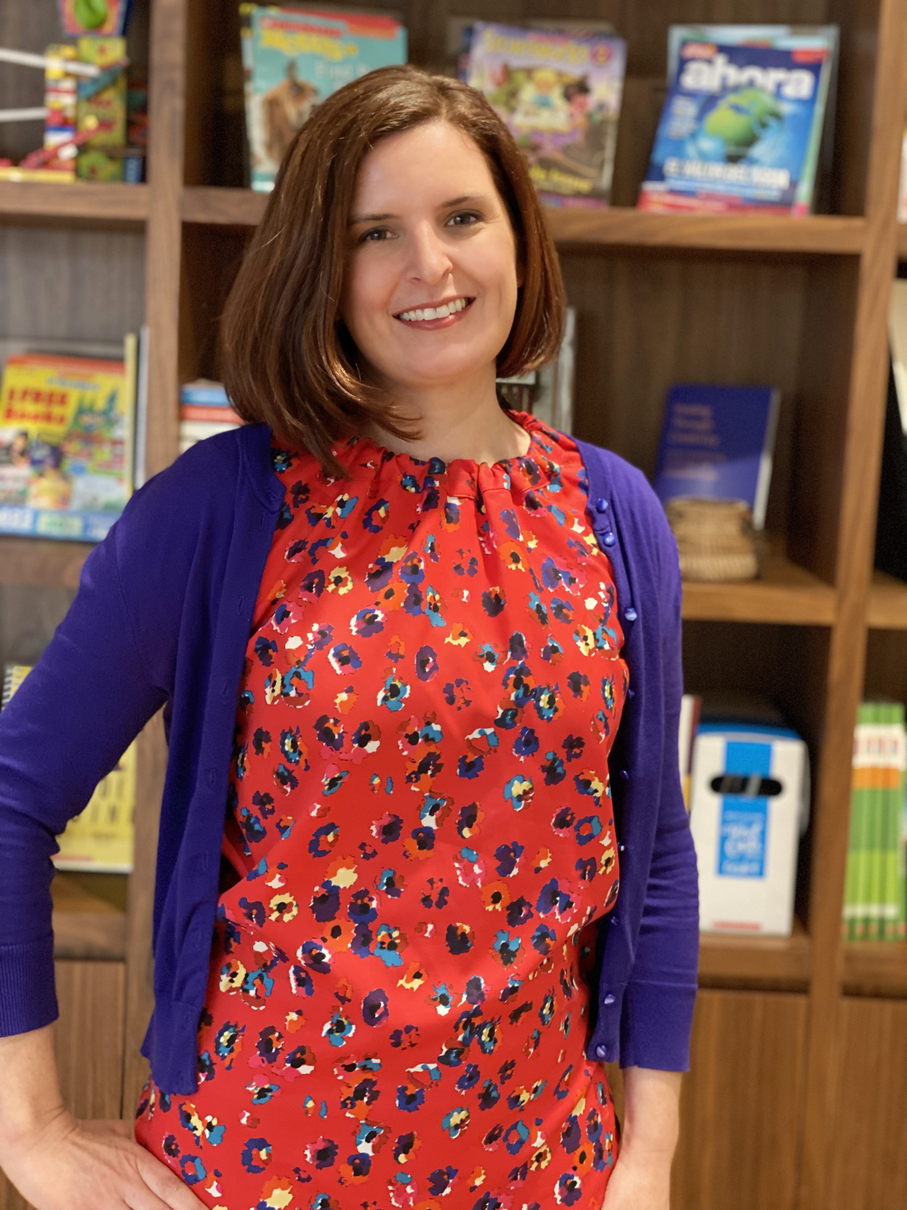 woman posing in front of bookshelf