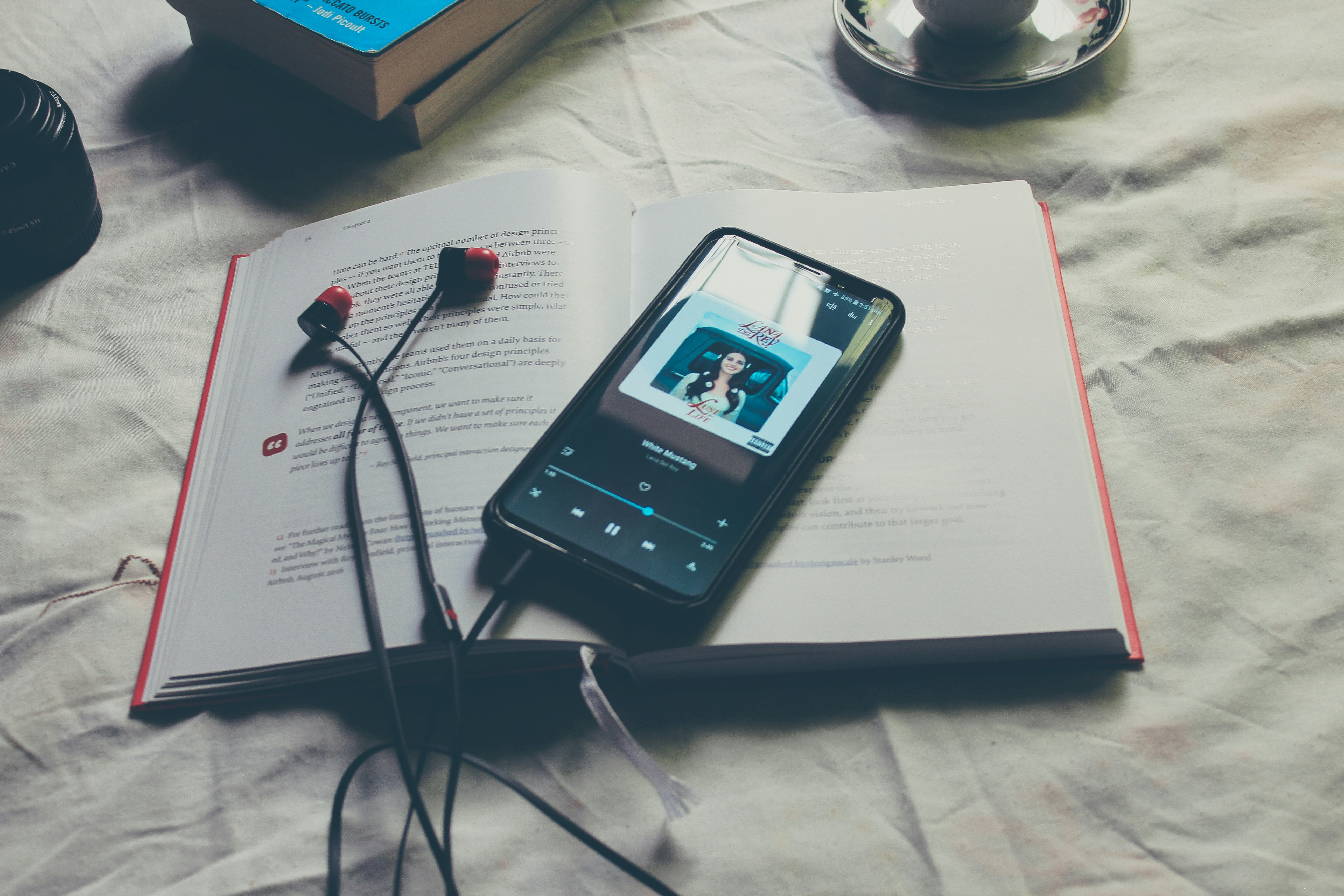 iPhone playing music on open book