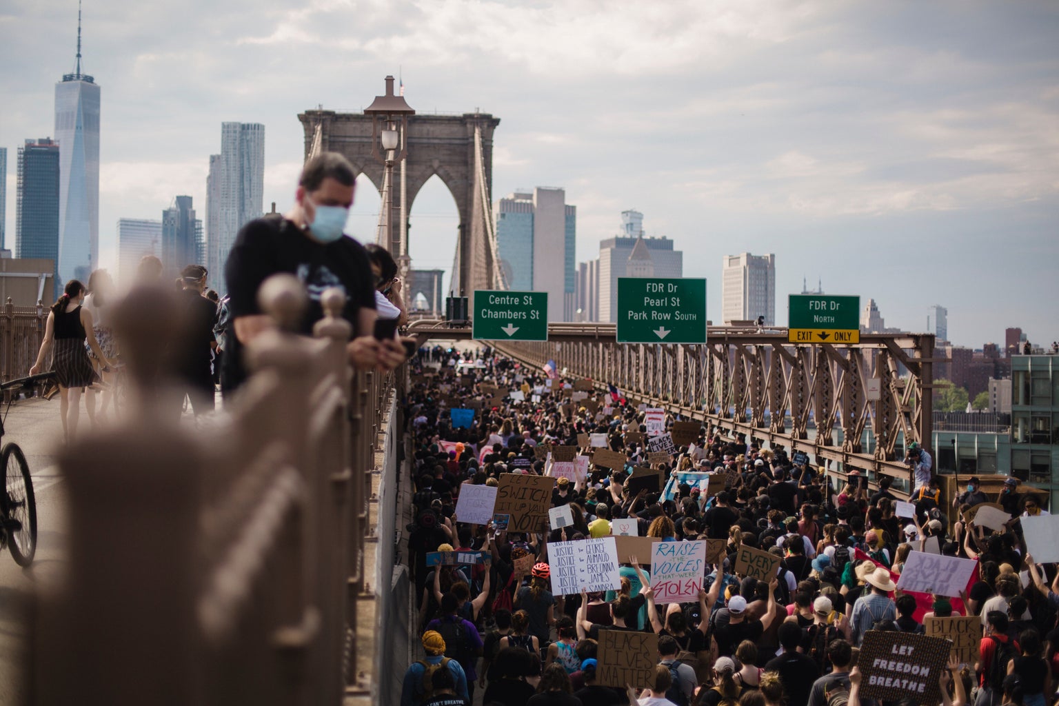 crowd of protesters on a bridge