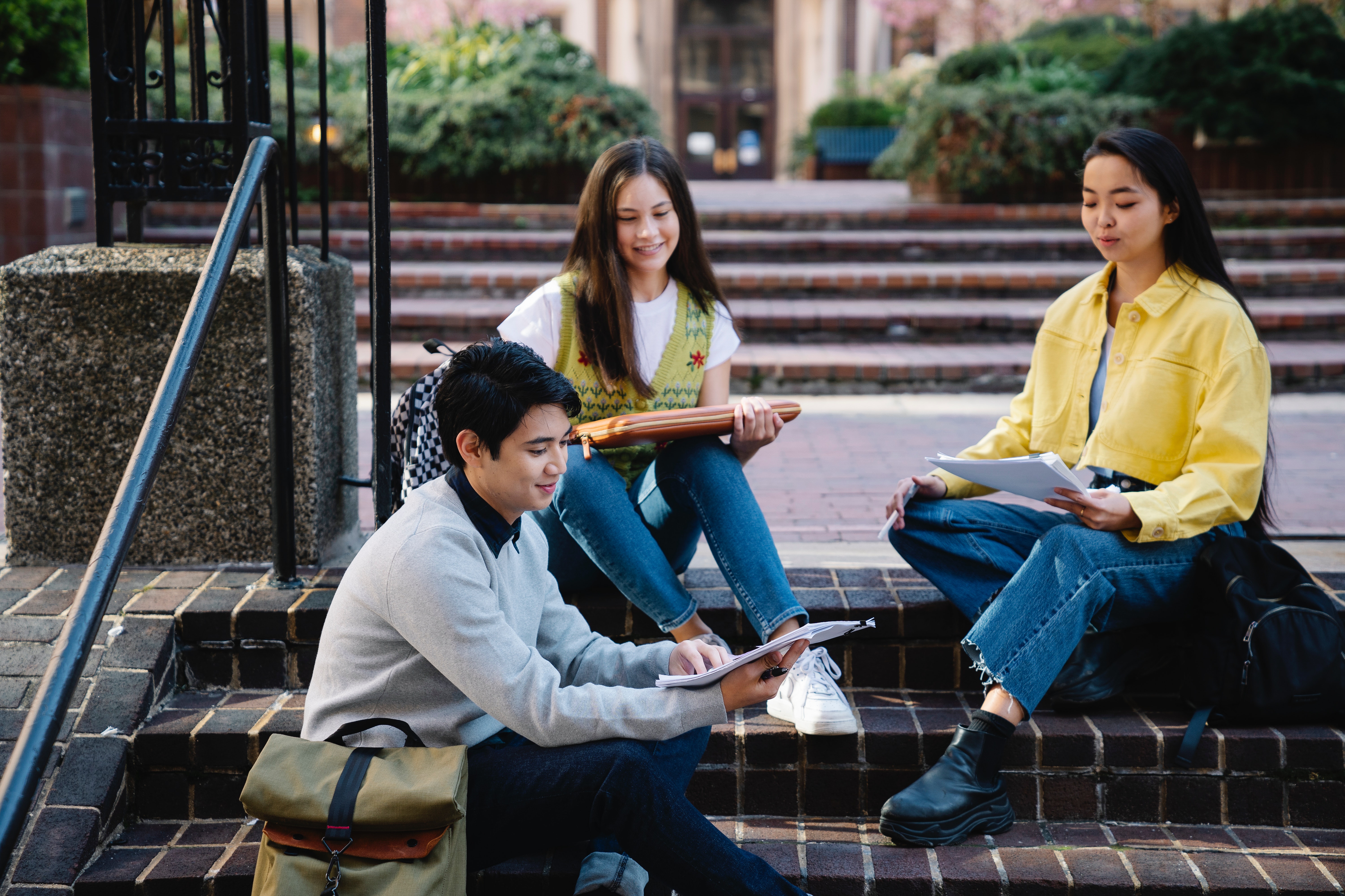 People sitting on stairs on campus