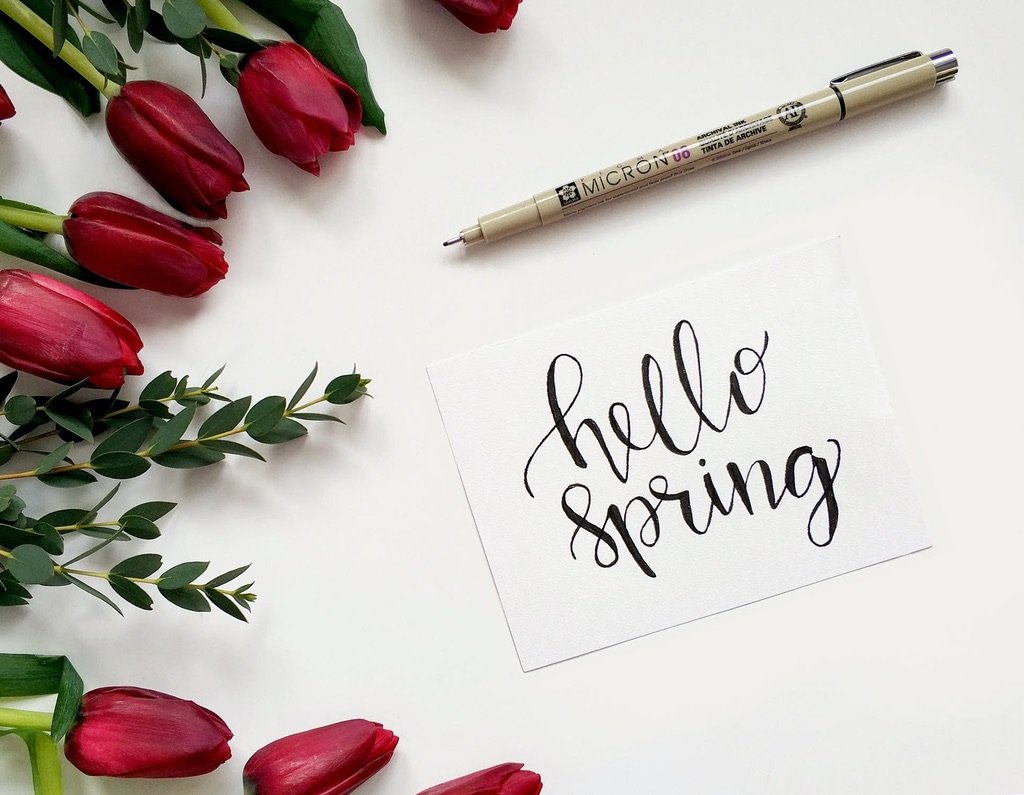 “Hello Spring” sign with pen and roses