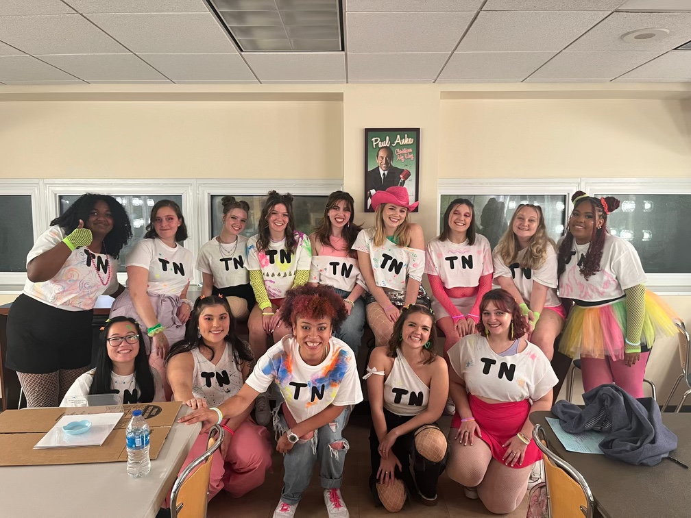 group of acapella singers Take Note in neon outfits