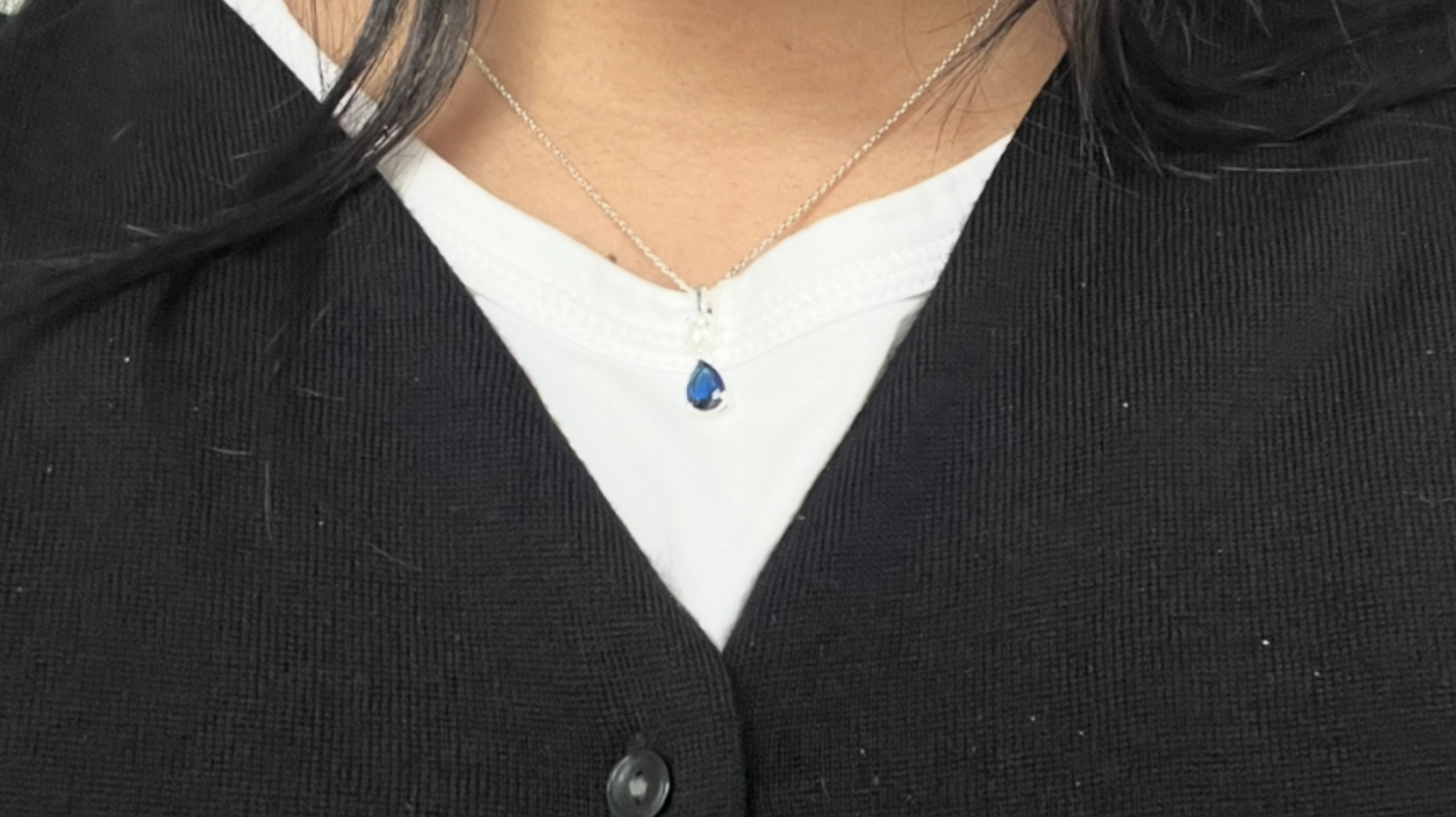Photo of author\'s clothes, close up on necklace