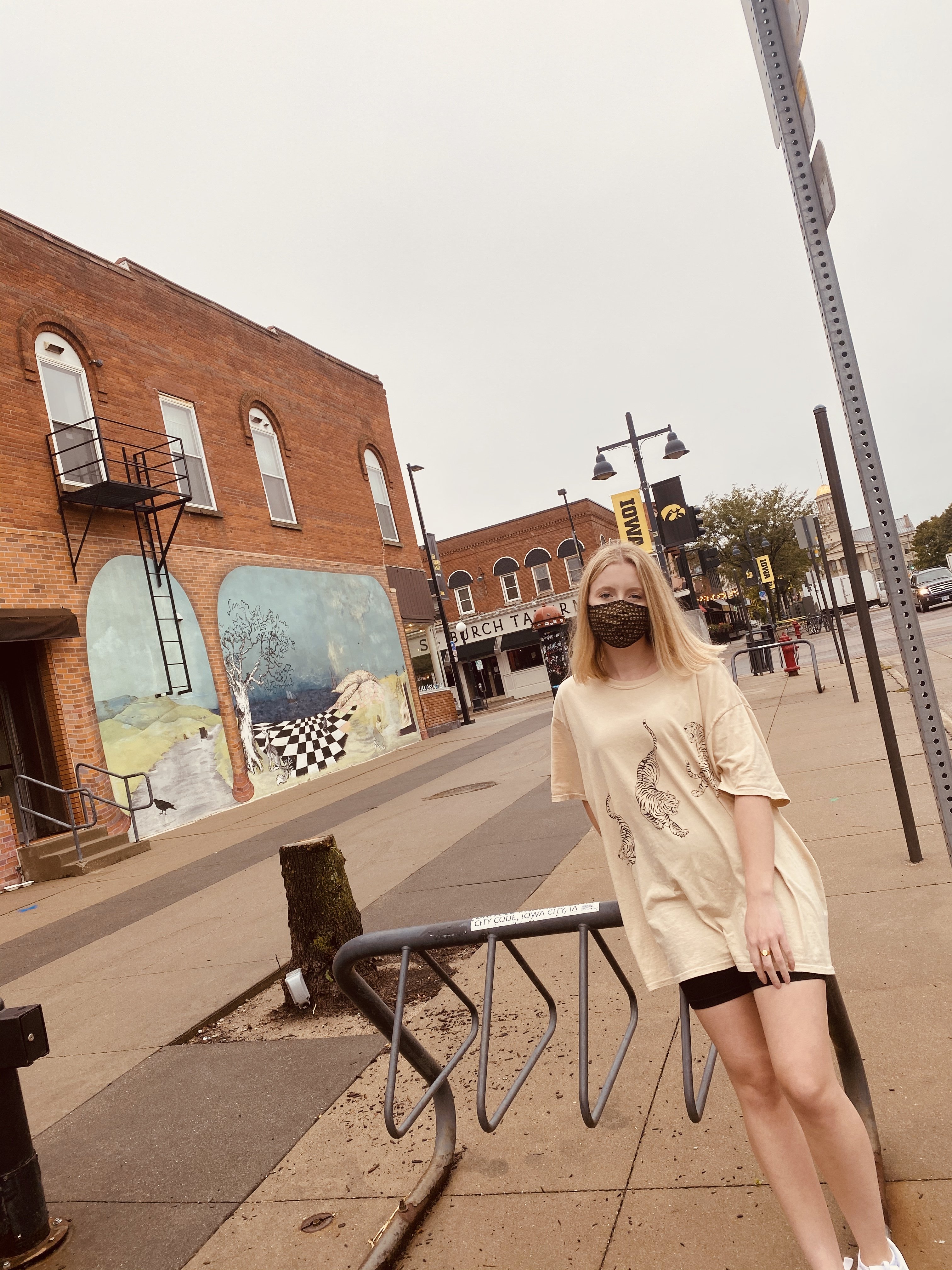 Girl leaned against bike rack in Iowa City