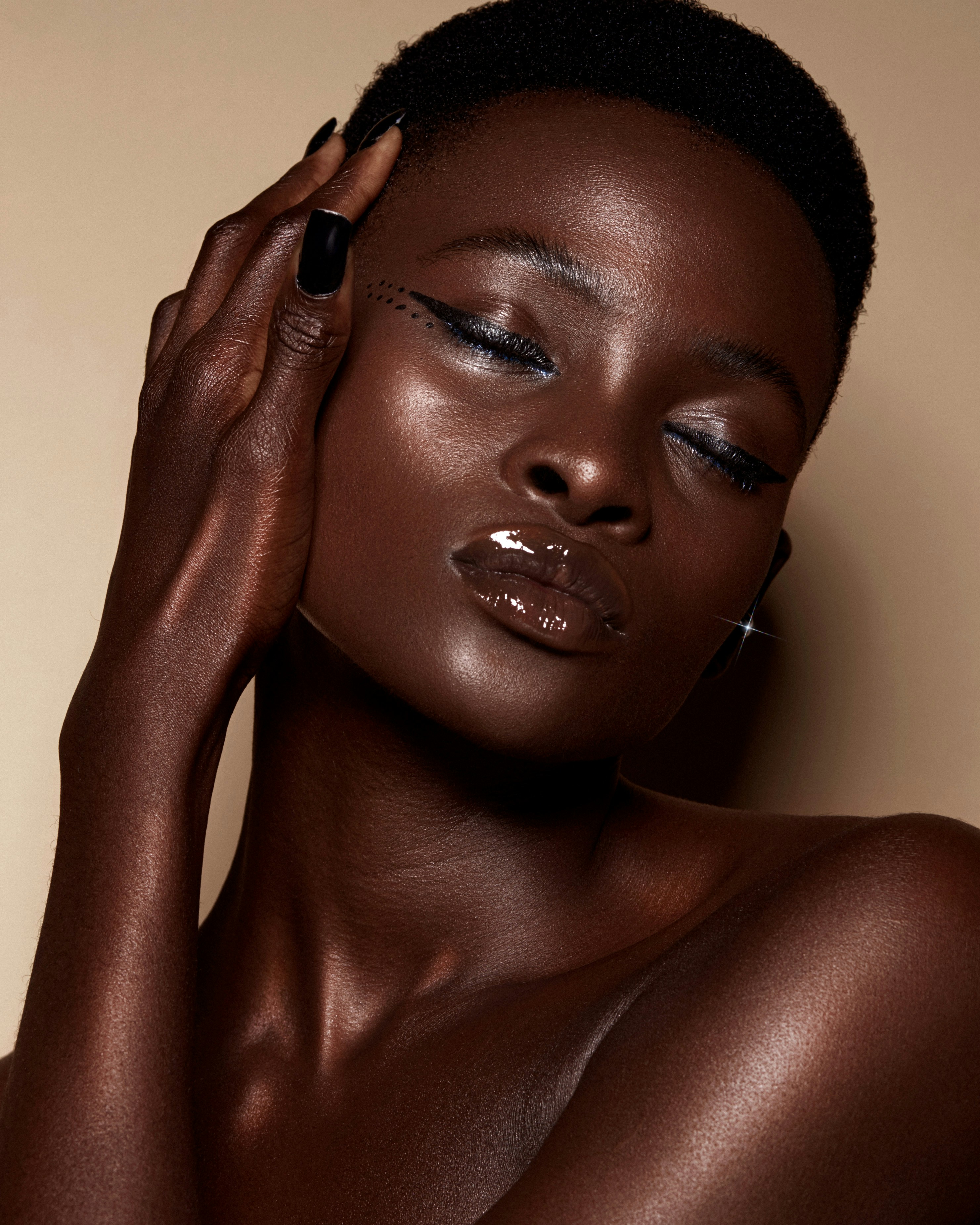 Model with a glossy brown lipgloss