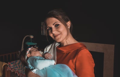 Smiling woman carrying baby