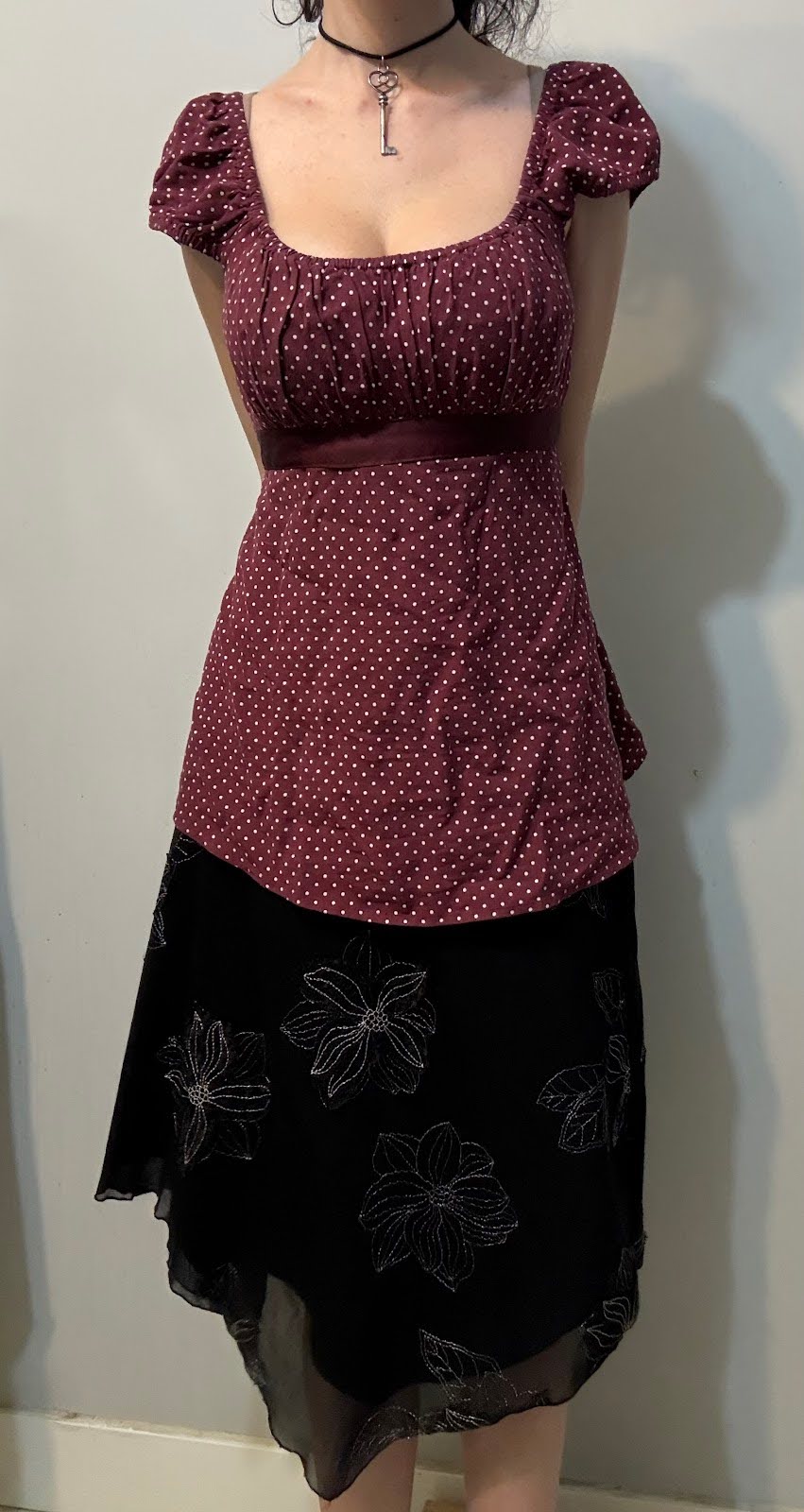 Outfit with a red polka-dot top and floral midi-skirt.