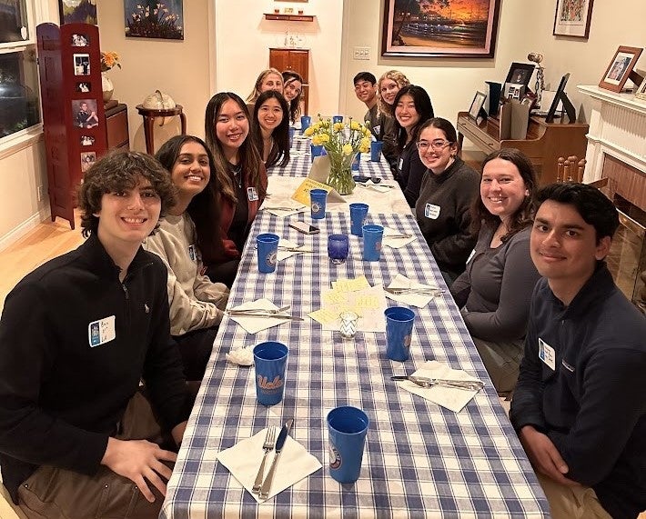 UCLA students at around a dinner table