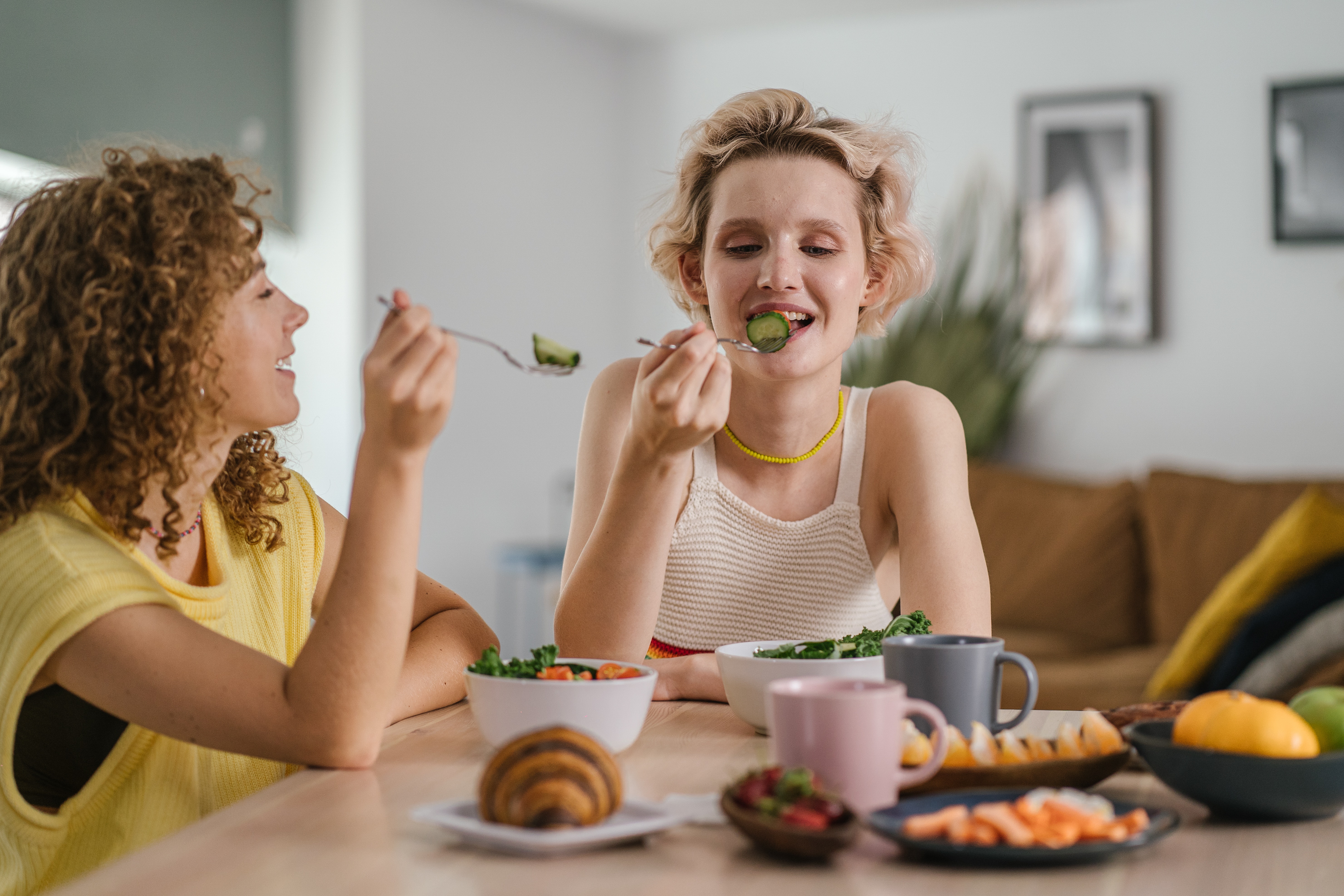 Women happily share a meal.