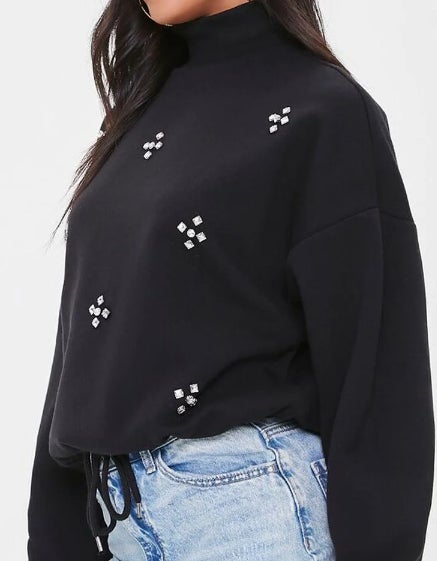 black sweater with small white crosses