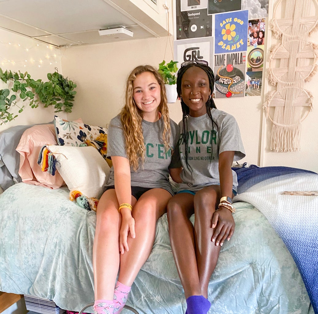 friends posing on a dorm bed