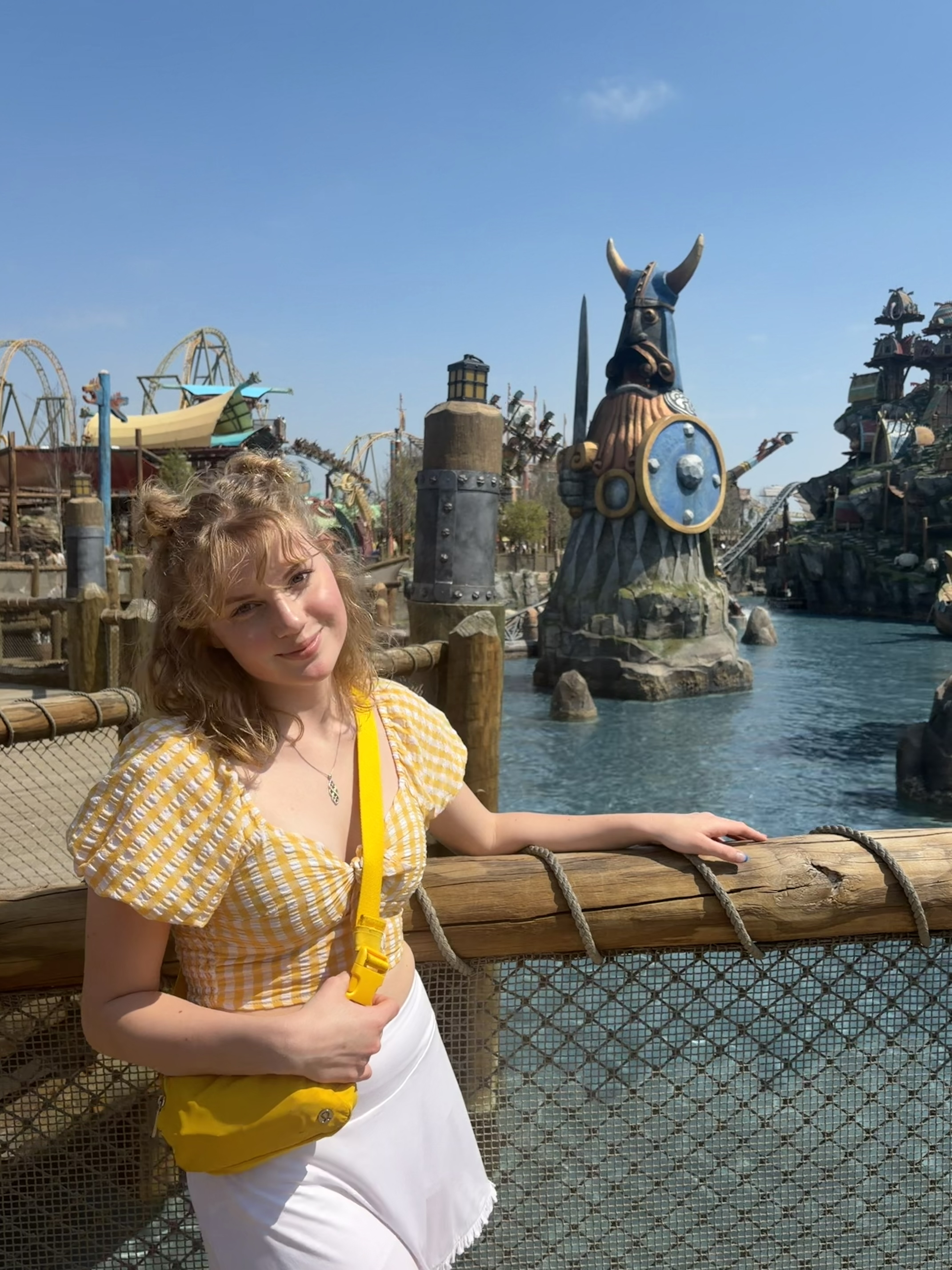 A girl standing in front of water